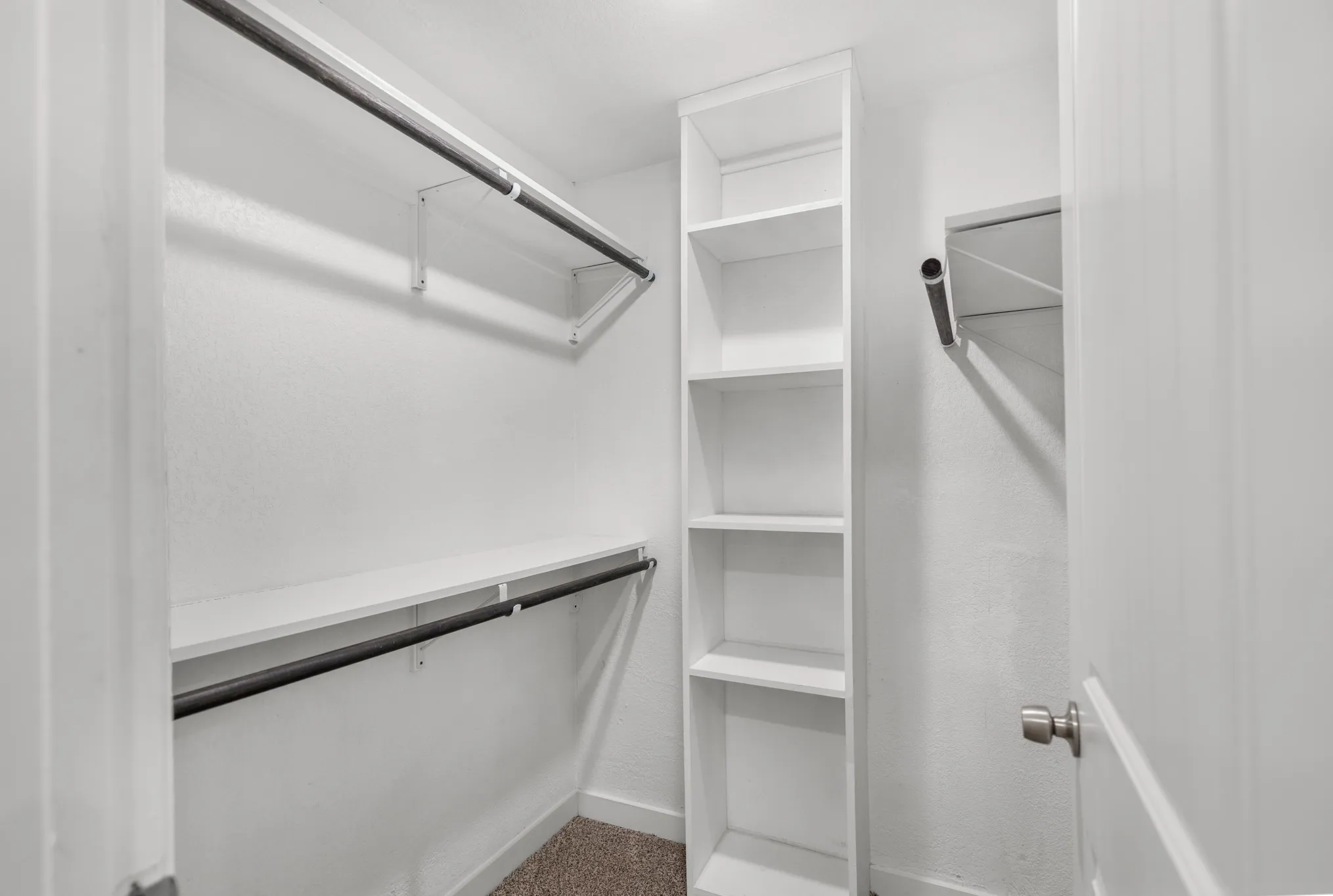 Built-in shelving unit, dual clothing rods, and overhead storage shelves