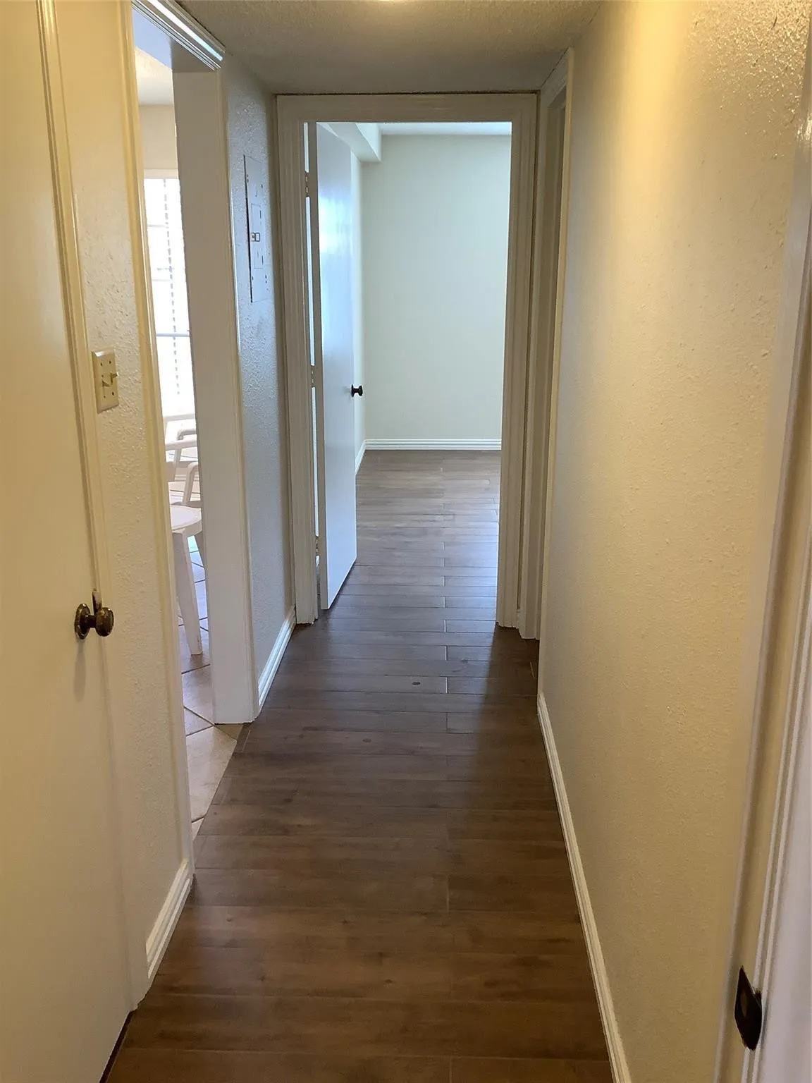 15 / 23From Master bedroom looking down hall to second bedroom. Kitchen to the left and bath to the right.