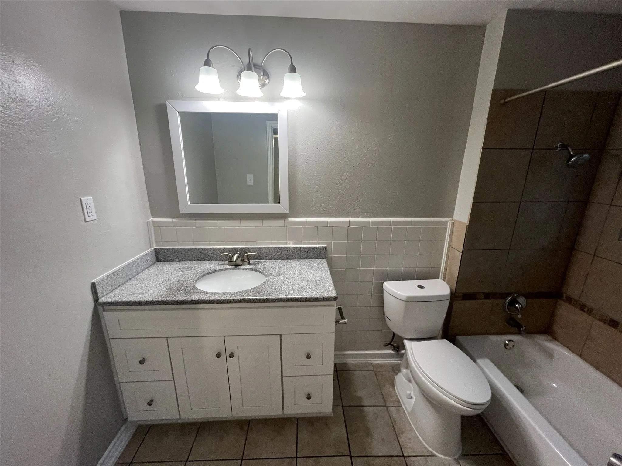 Vanity with a light-colored countertop, white cabinetry, and an undermount sink