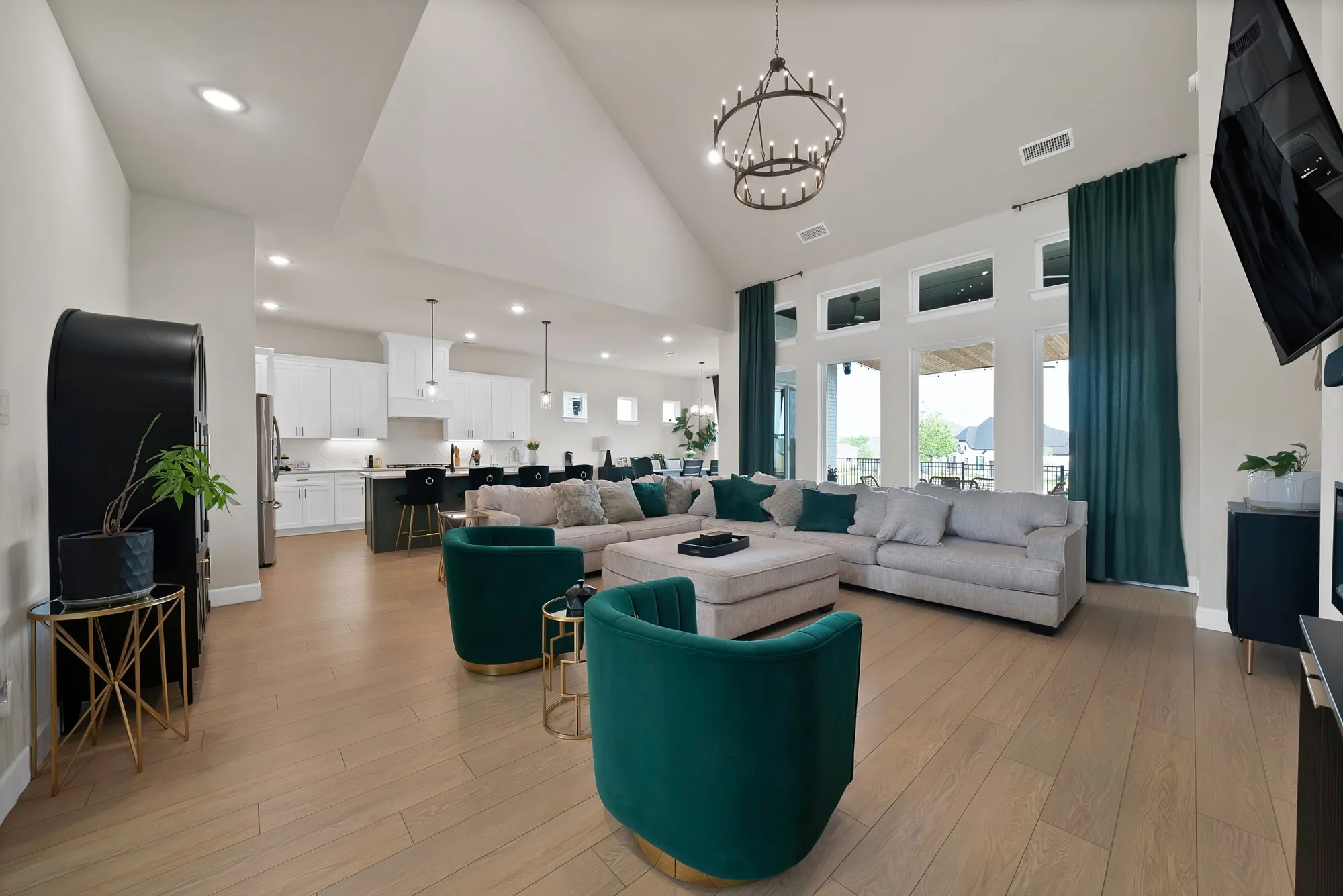 Vaulted ceiling with a chandelier, wood-finish flooring, recessed lighting, and expansive windows