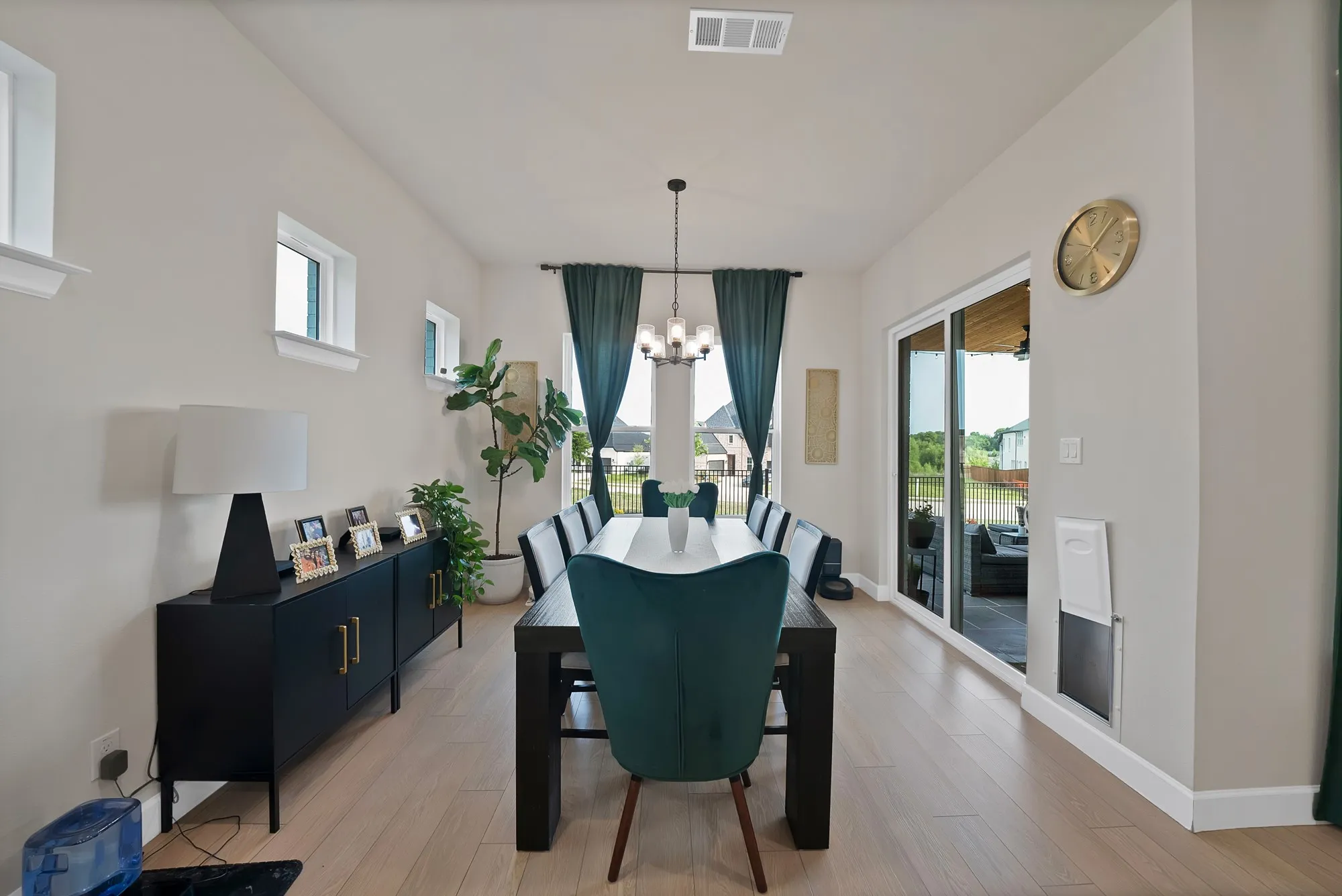 Light wood-finish flooring, recessed lighting, and a sliding glass door