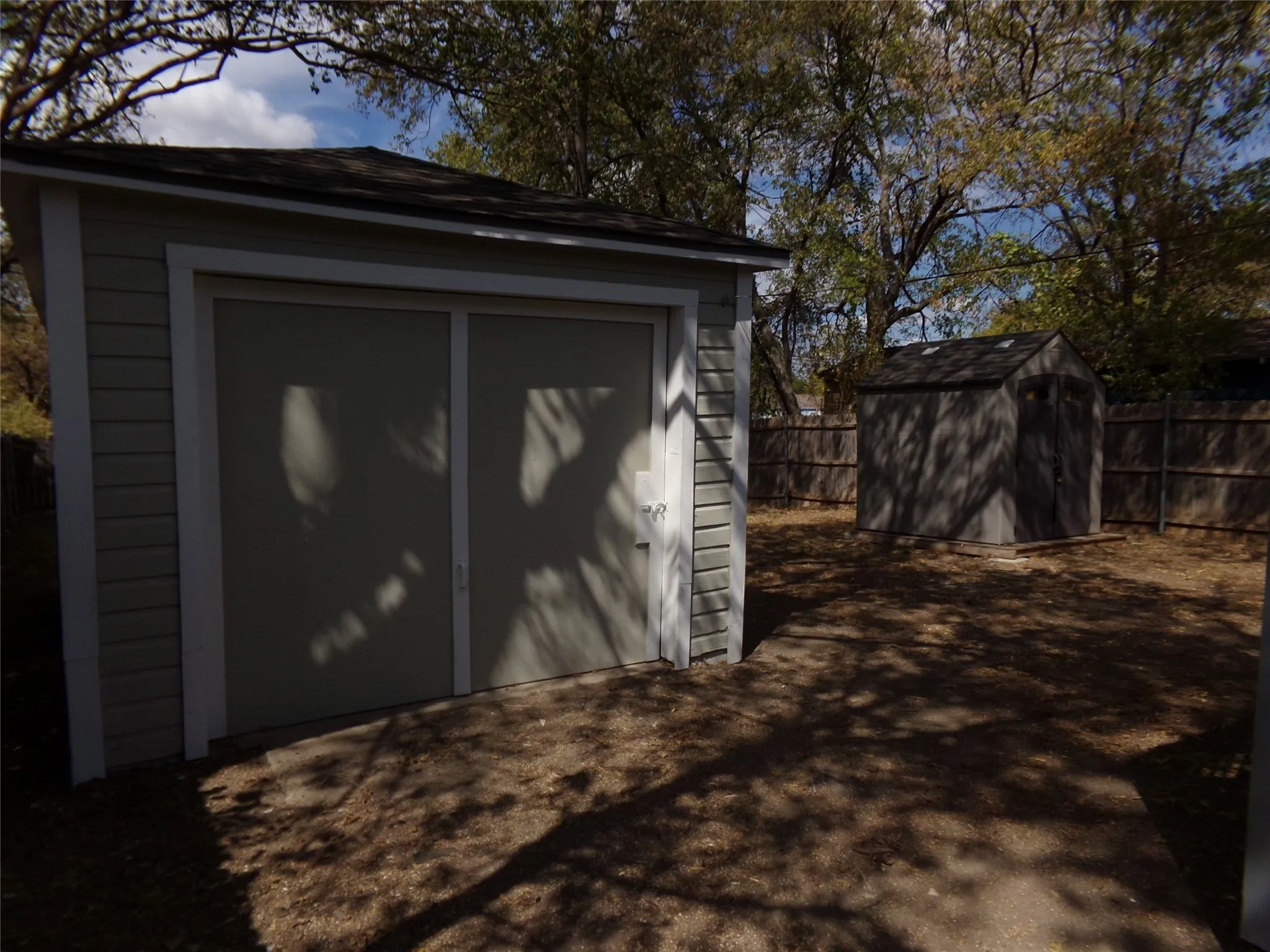 Detached garage with horizontal siding and a dual-panel door