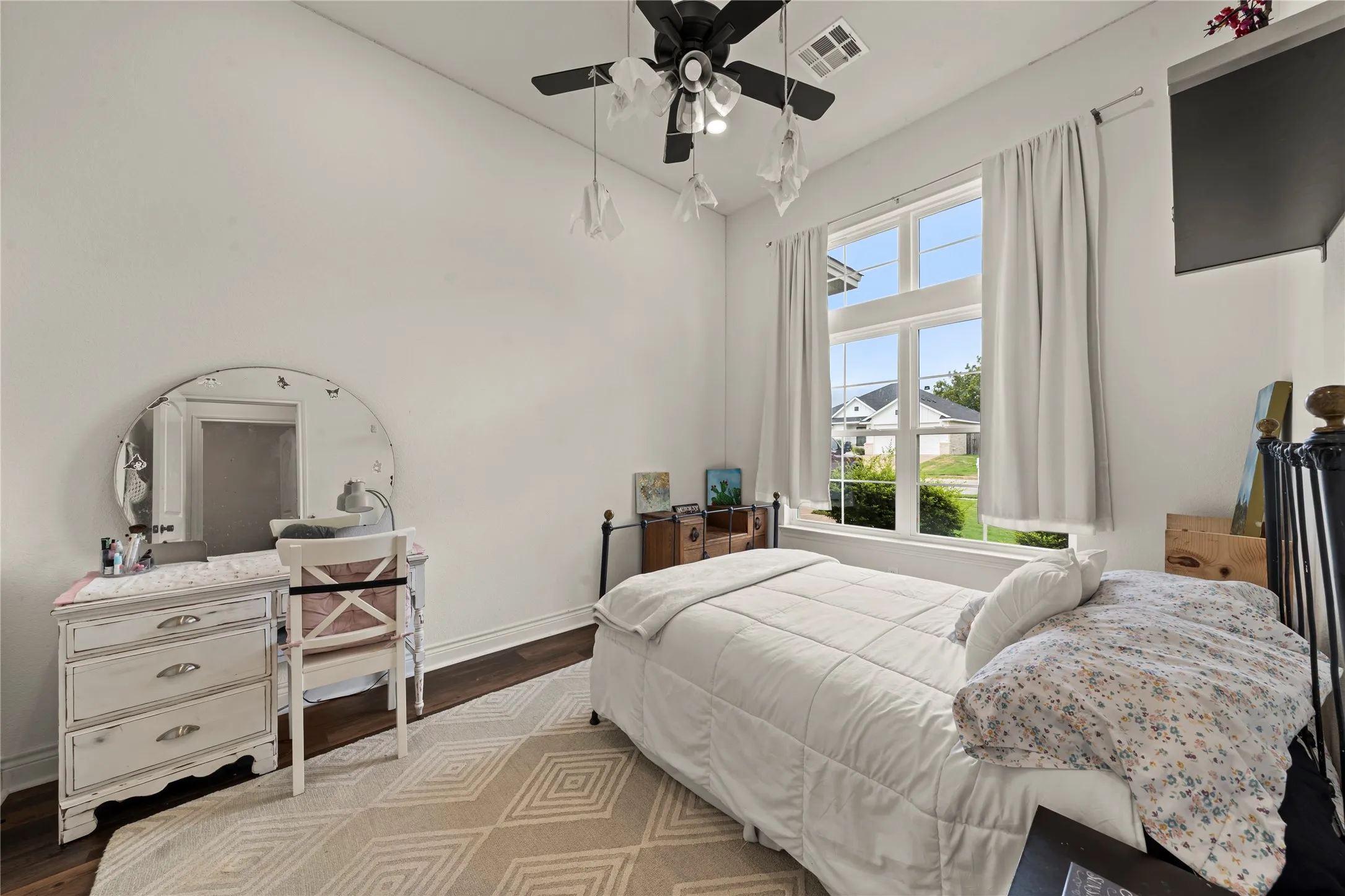 Hardwood-finish flooring, white walls, and a multi-pane window with transom detail