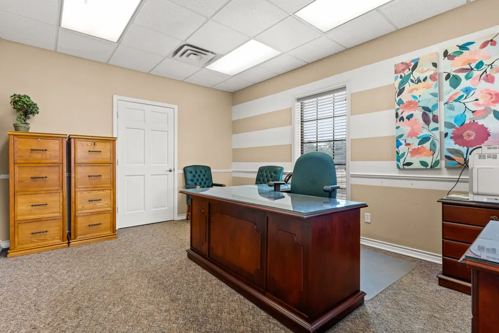 Recessed lighting, drop ceiling, window with blinds, paneled door, and neutral-toned walls with chair rail trim
