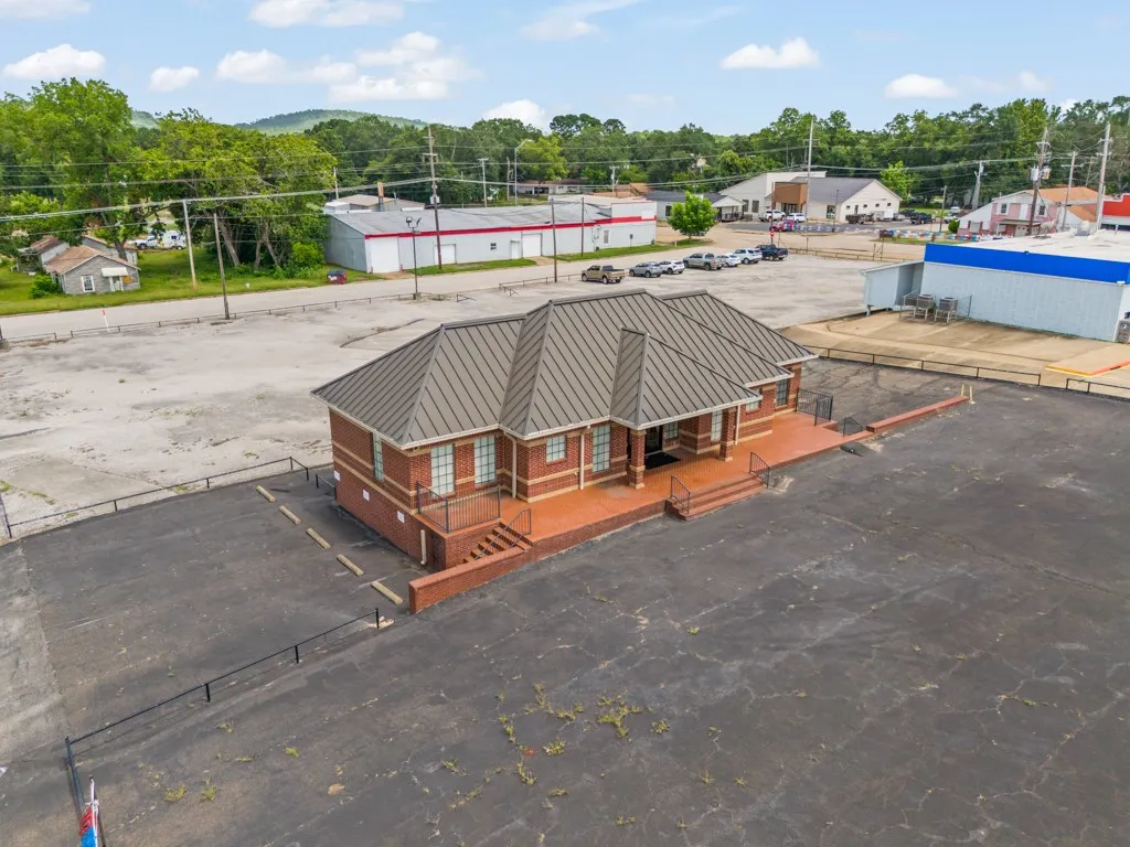 Brick exterior building with a gray standing seam metal roof