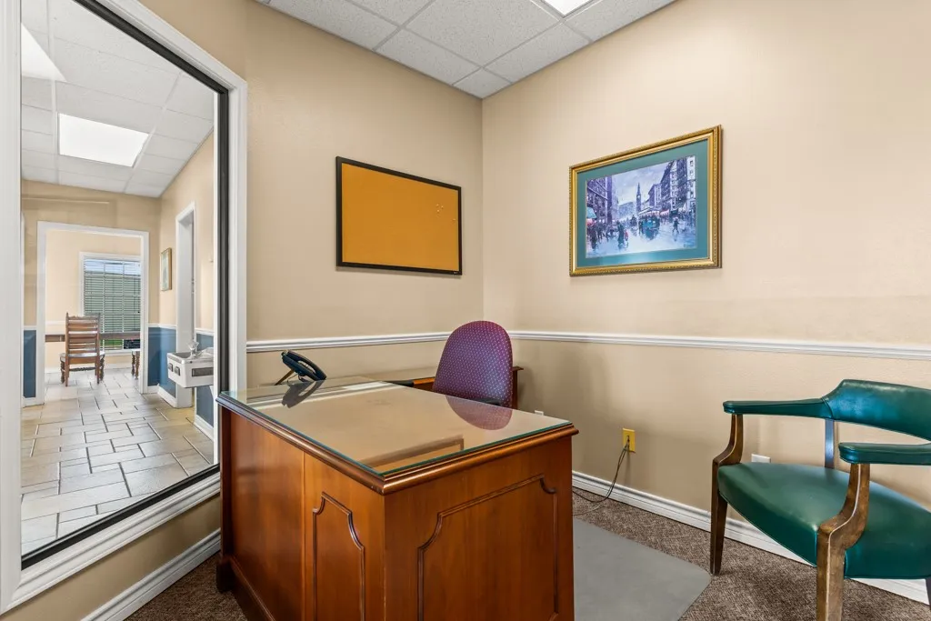 Private office space featuring wall-to-wall carpeting and neutral wall tones