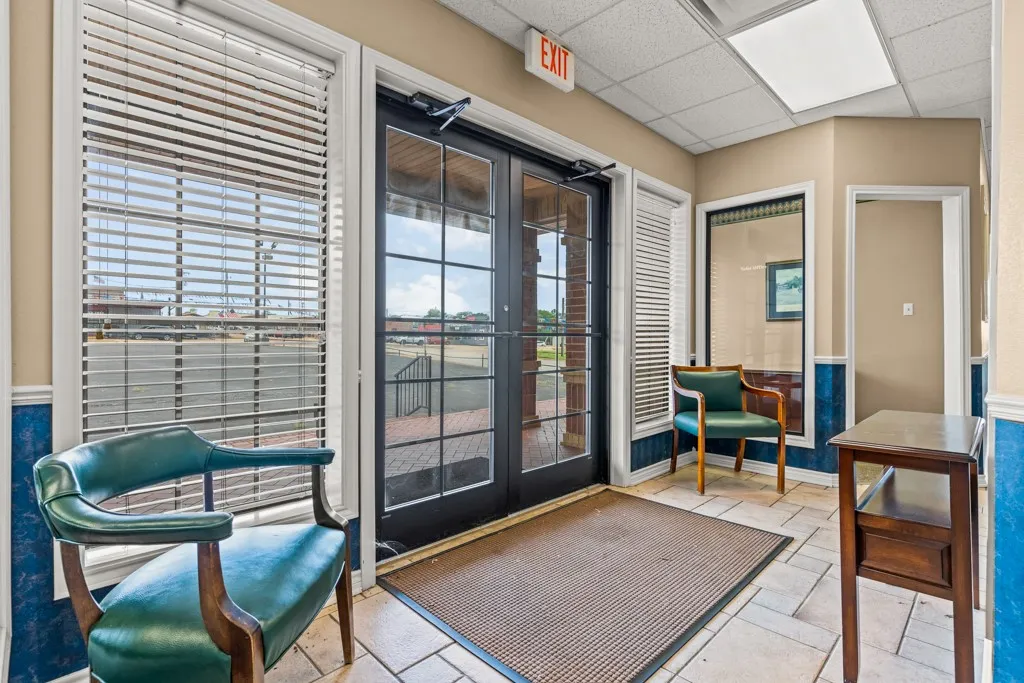 Entryway featuring double glass-panel doors, tiled flooring, horizontal blinds, and recessed lighting