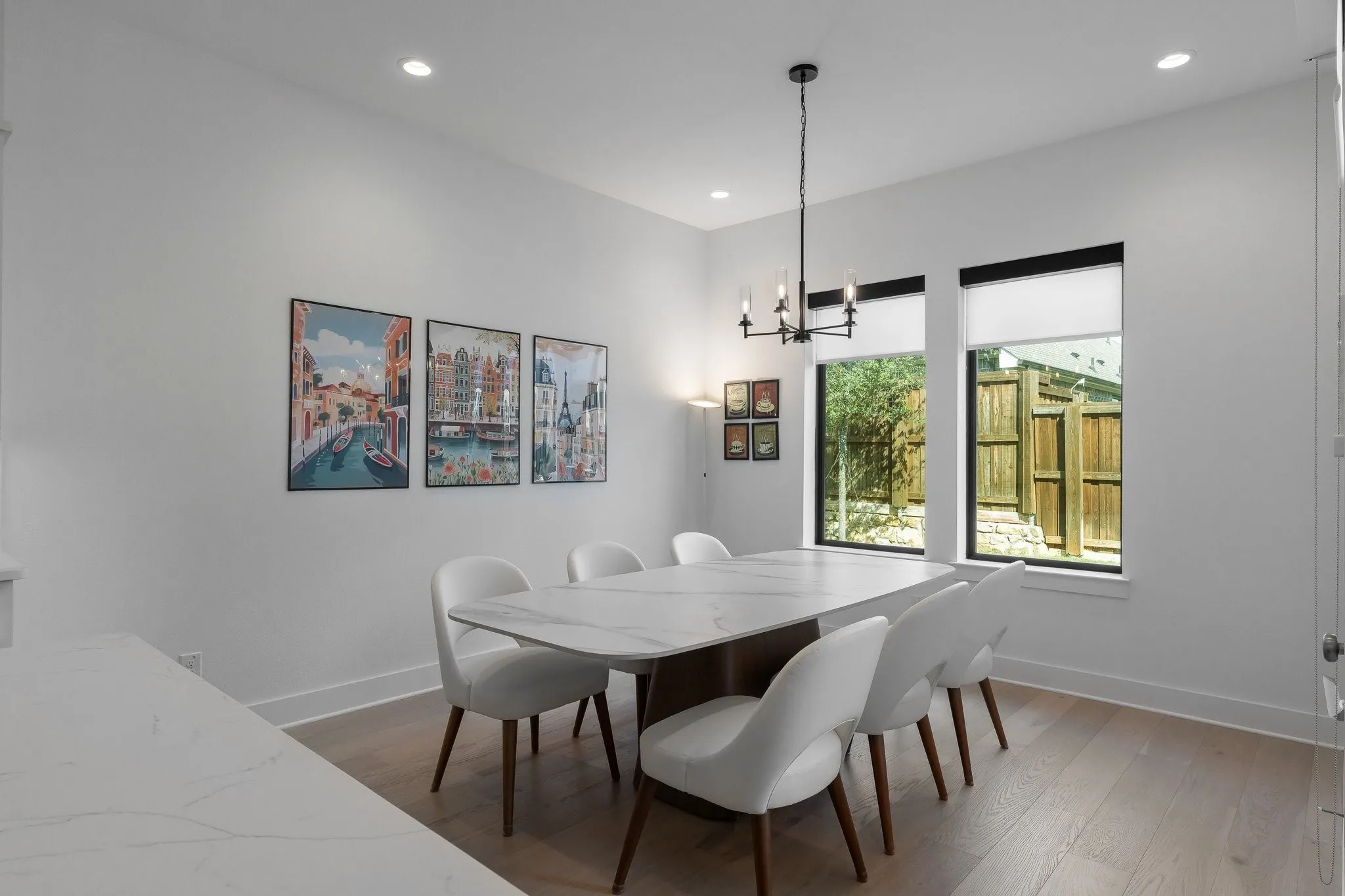 Recessed ceiling lighting, wood-finish flooring, and a modern chandelier