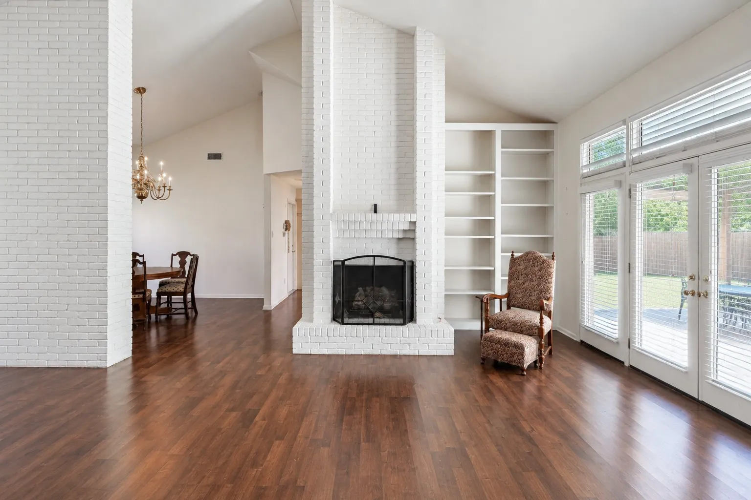 Floor to ceiling bookcases & fireplace with gas logs