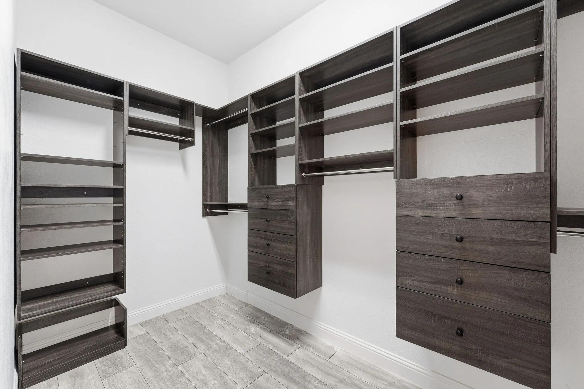 Primary closet with tons of shelving