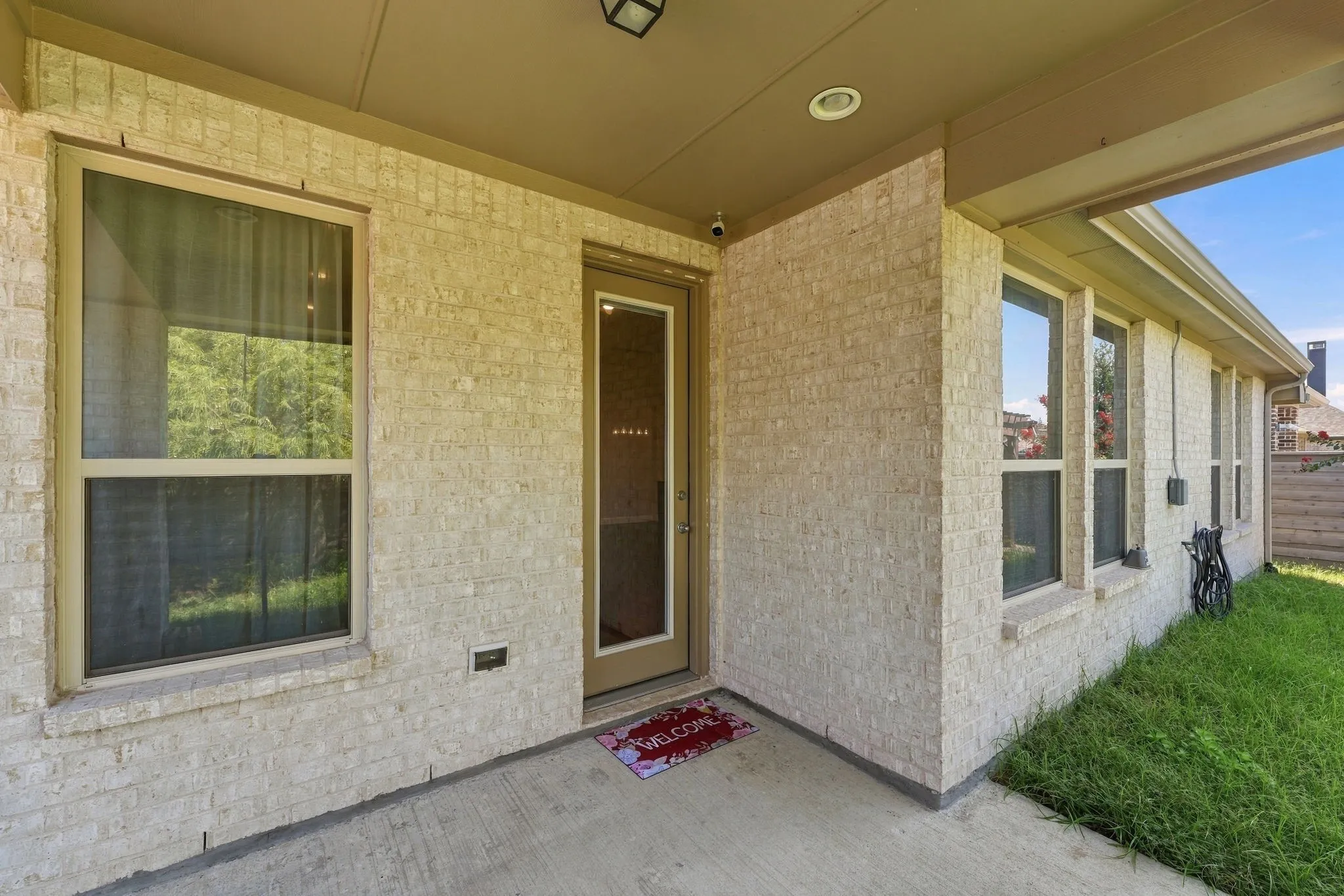 Covered backyard patio includes a gas stub out for a grill.