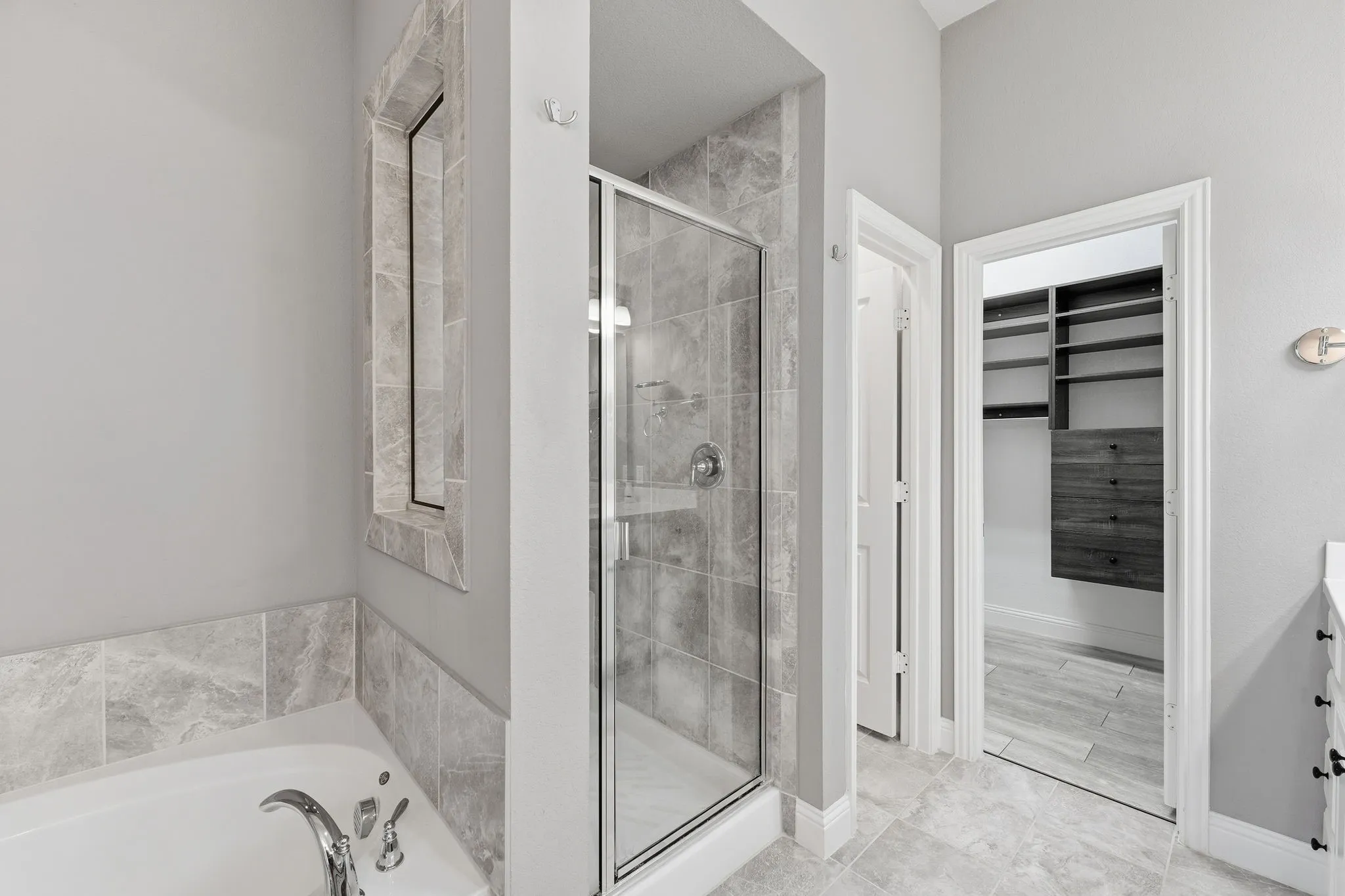 Separate soaking tub and walk-in shower with seat.