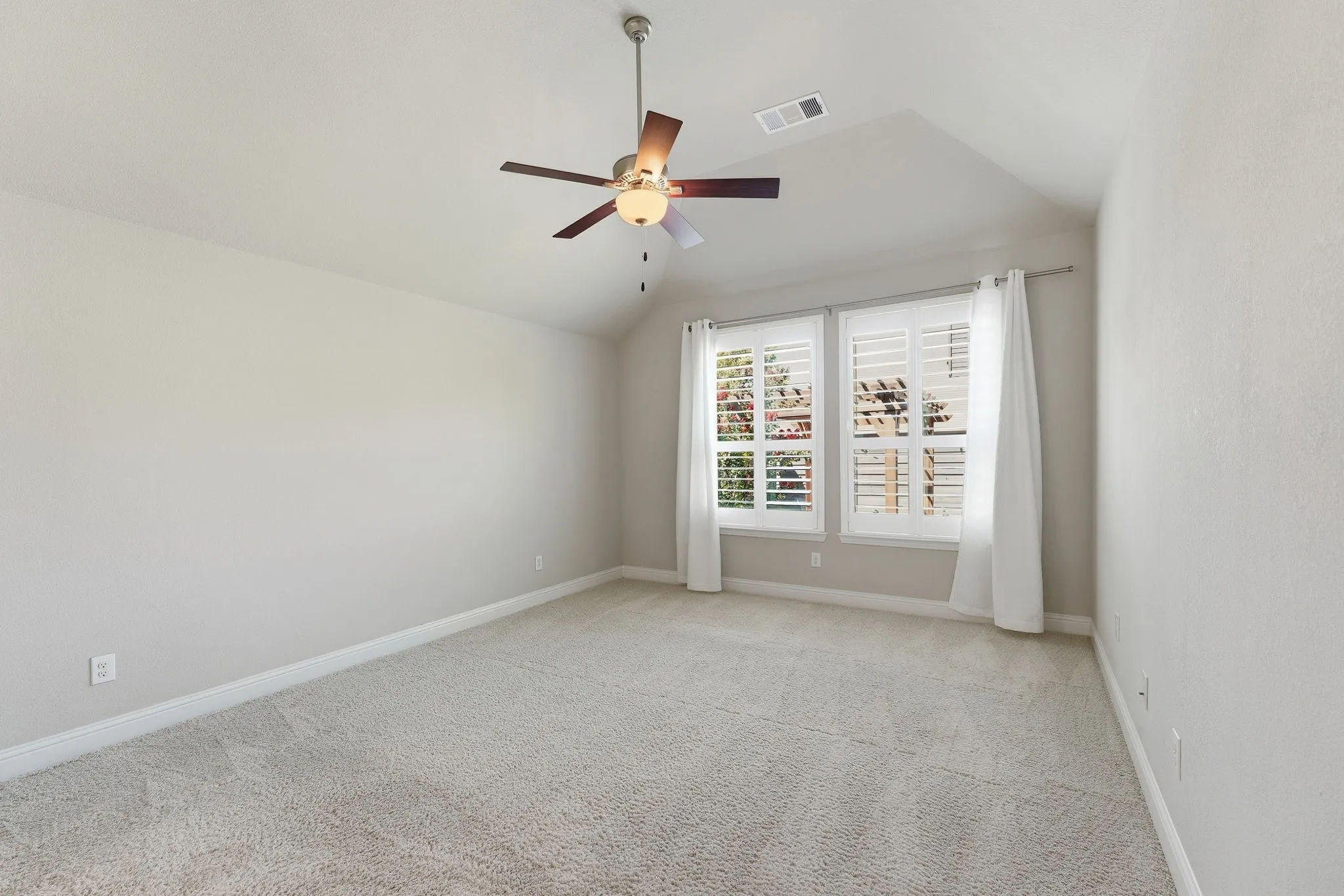 Tucked away in back is the primary suite with great view of backyard