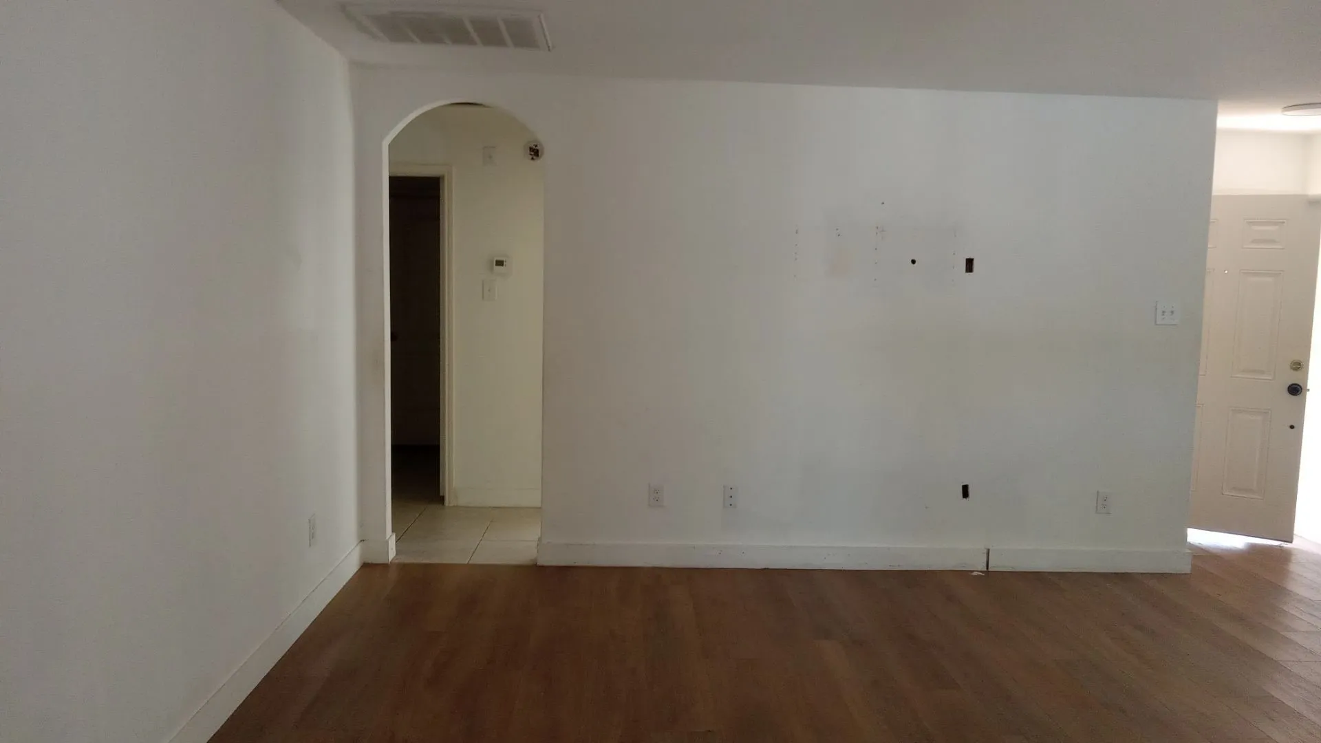 Wood-finish flooring with white walls and trim