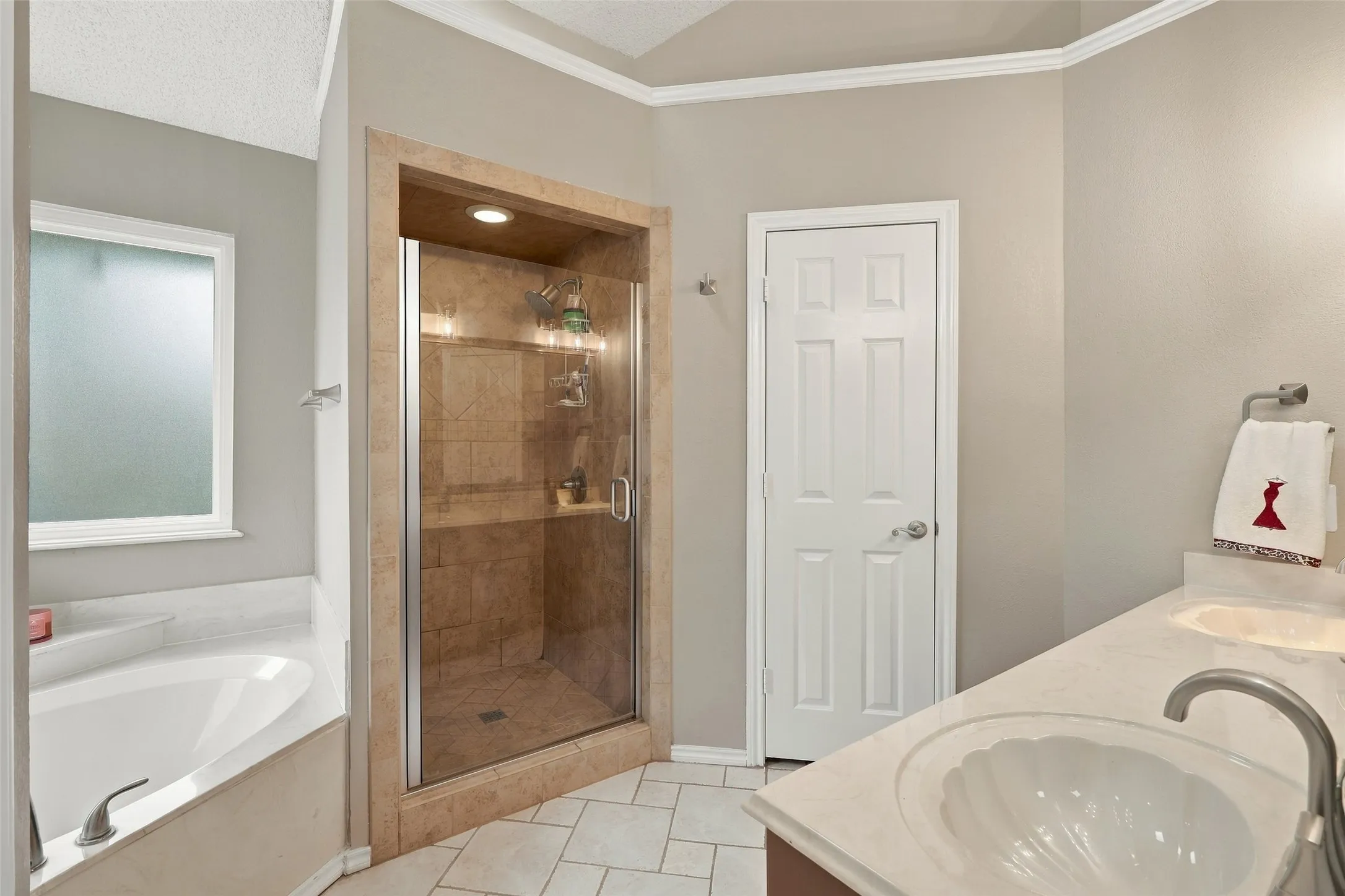 Primary bathroom with garden tub and separate shower. Dual vantities
