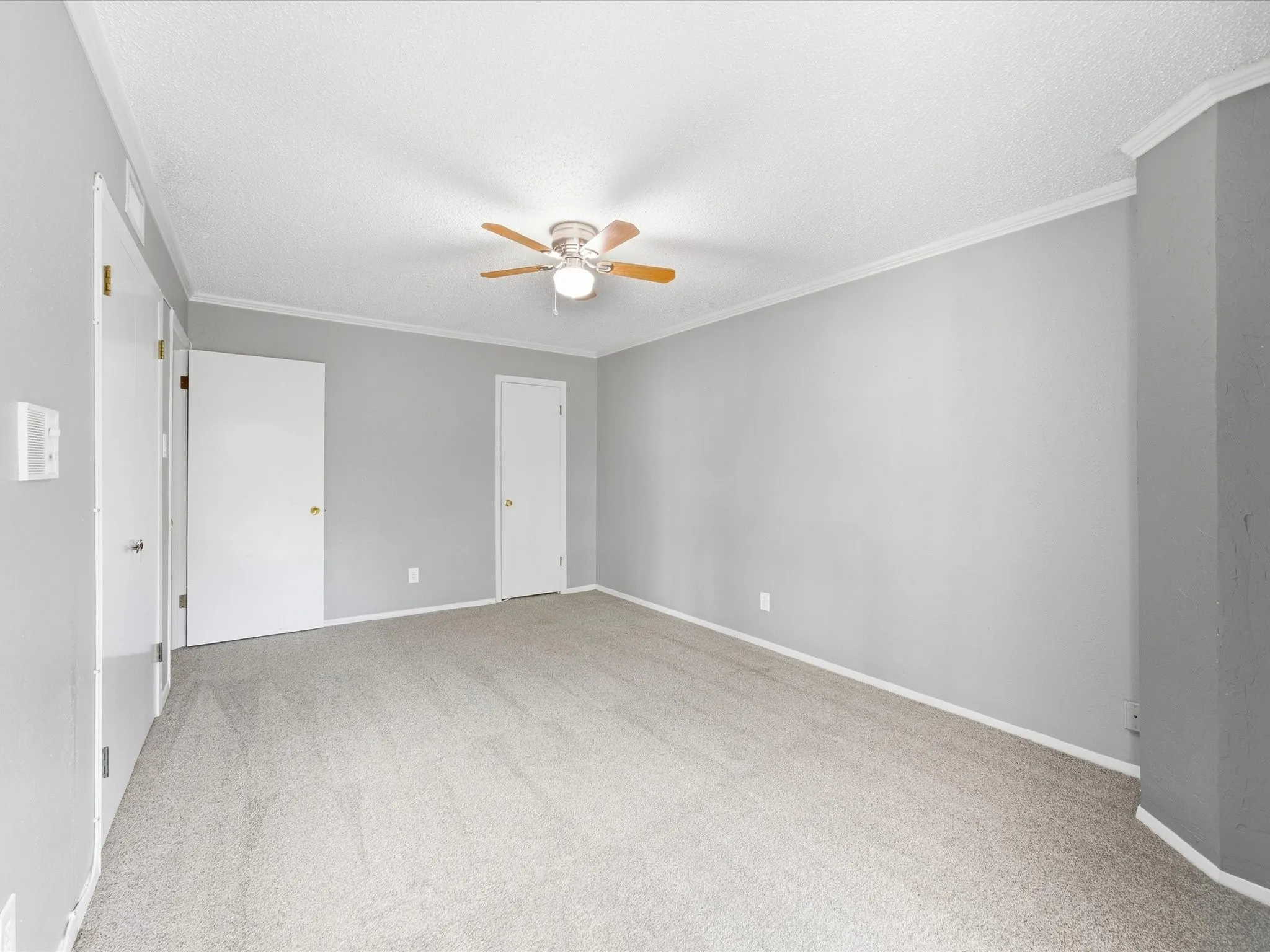 Neutral-toned walls complement the light-colored carpeting