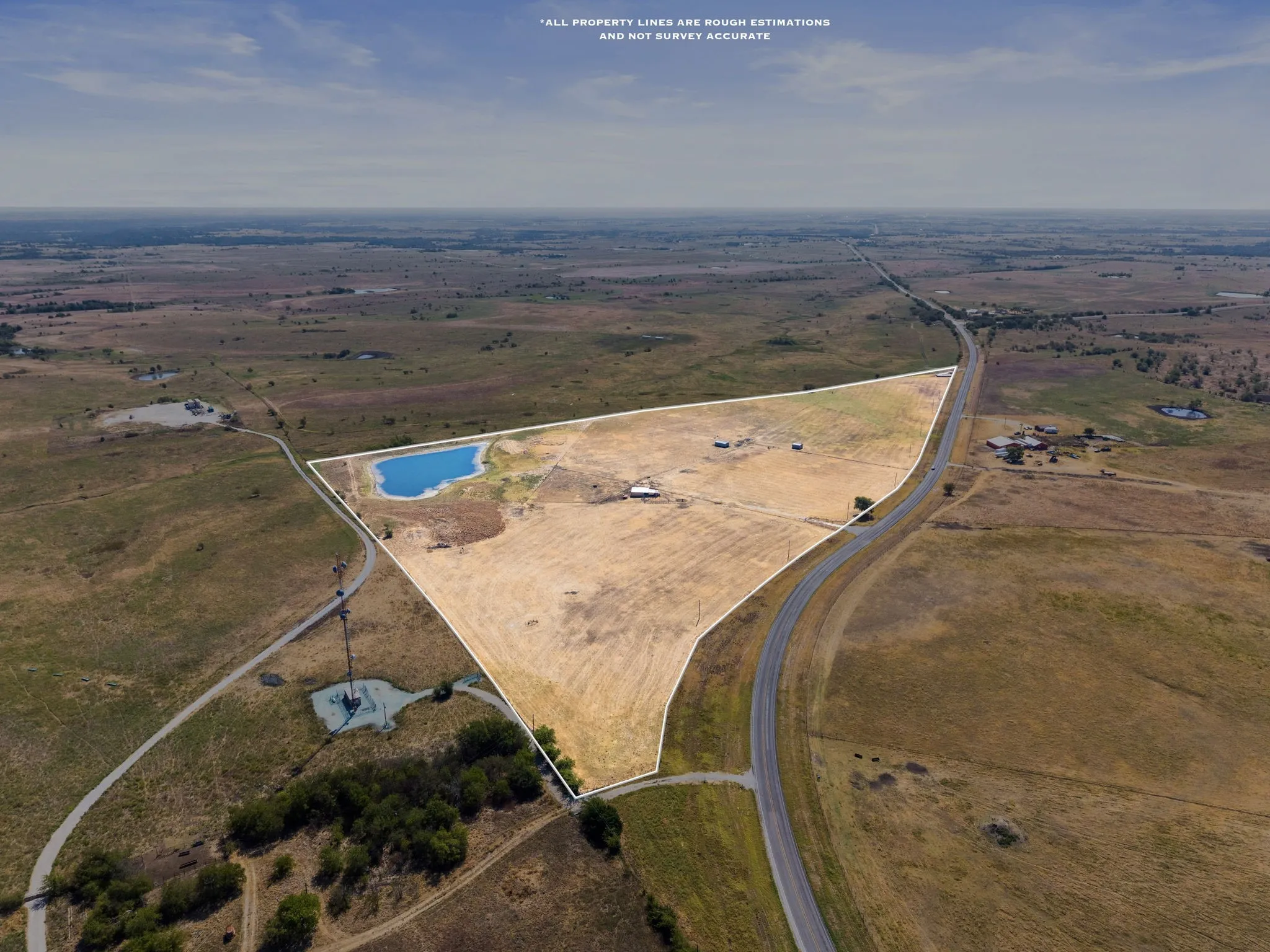 Expansive rural acreage with a private pond, open fields, and direct road frontage
