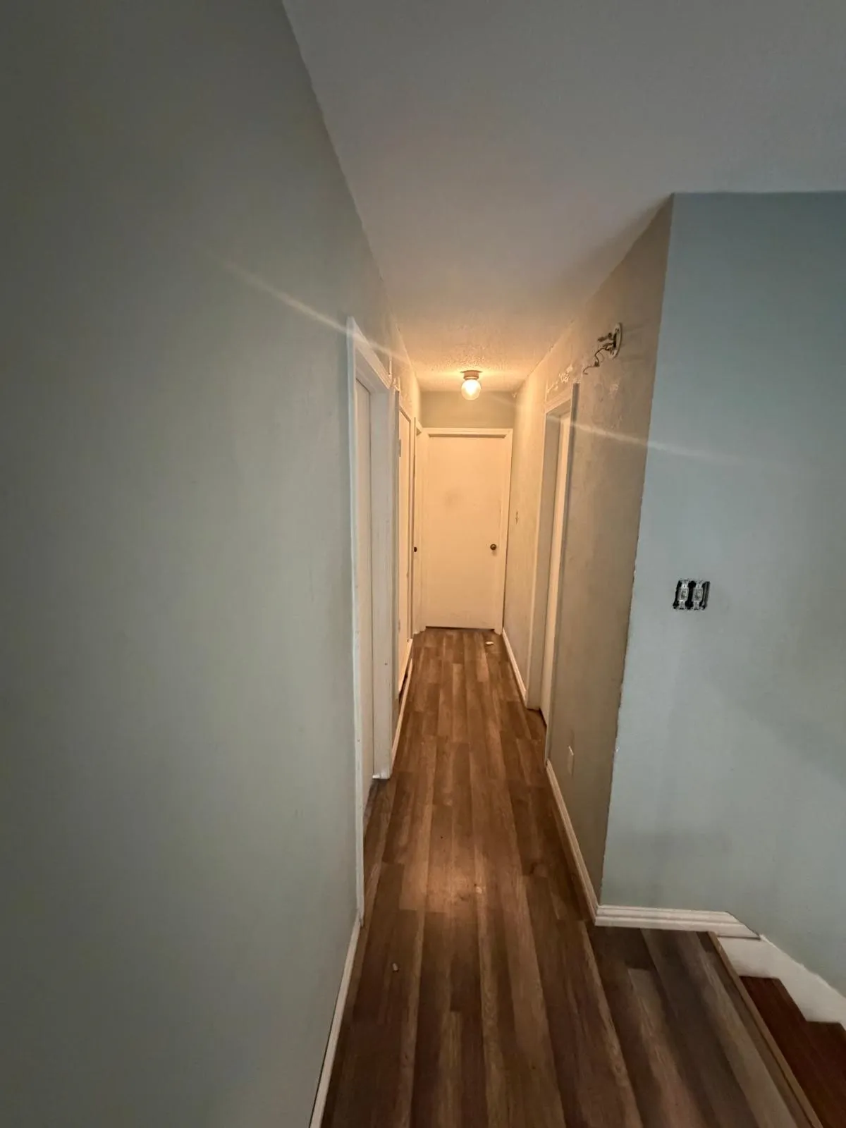 Wood-finish flooring extending through the hallway