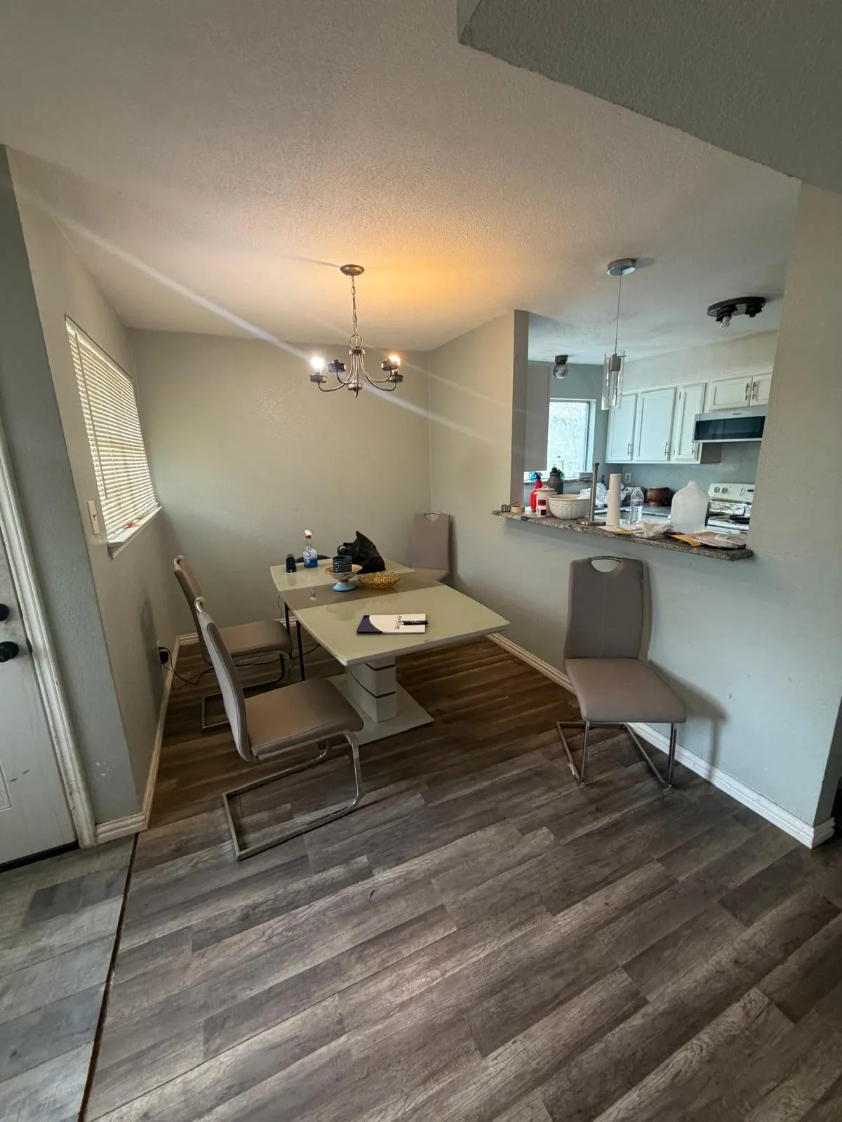 Wood-finish flooring throughout, with a window featuring blinds