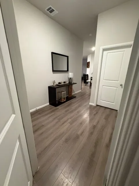Wood-finish flooring throughout the hallway