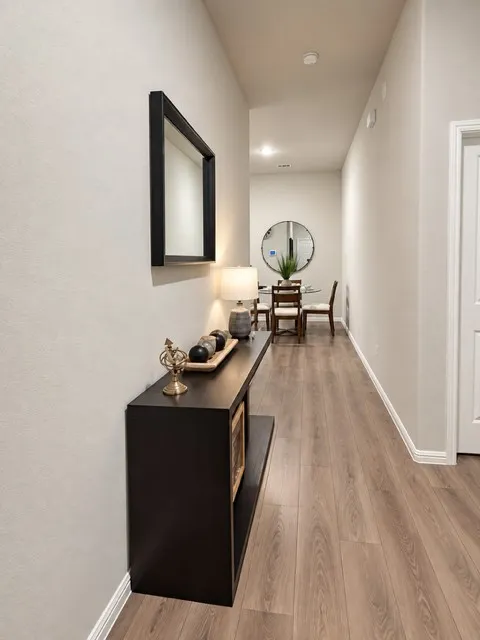 Wood-finish flooring throughout the hallway