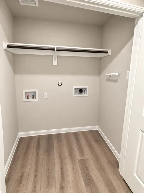 Dedicated utility space featuring a built-in shelf and hanging rod