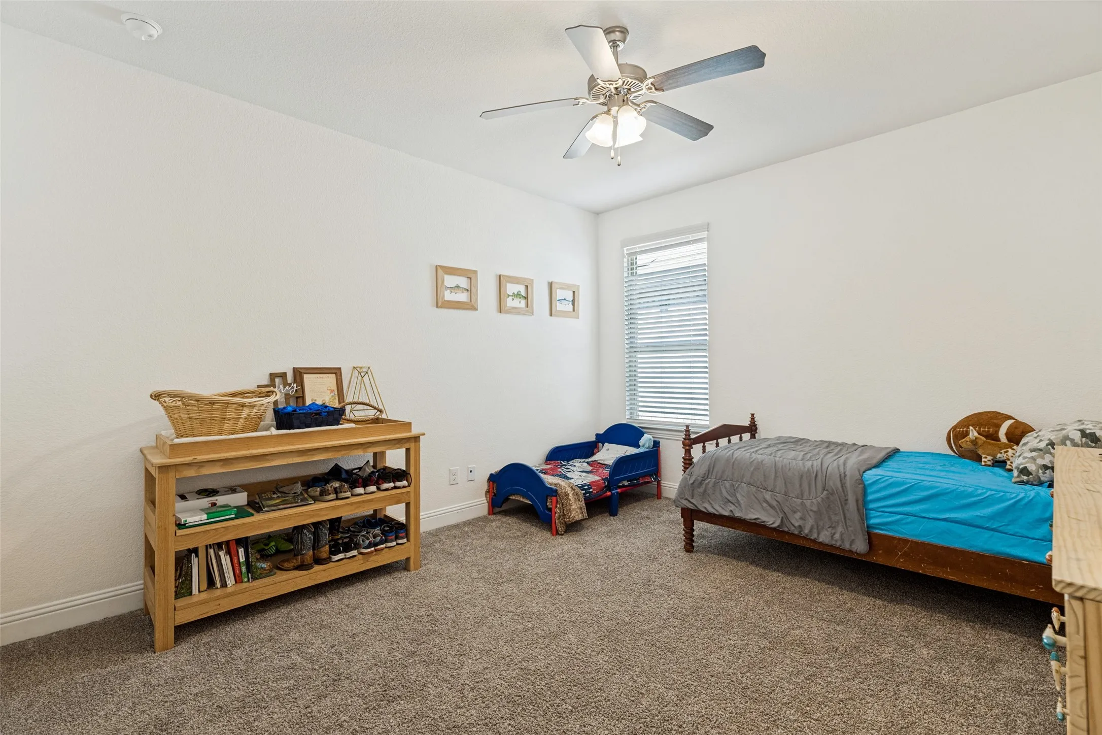Carpeted flooring, window with blinds, ceiling fan with light fixture, and neutral wall tones