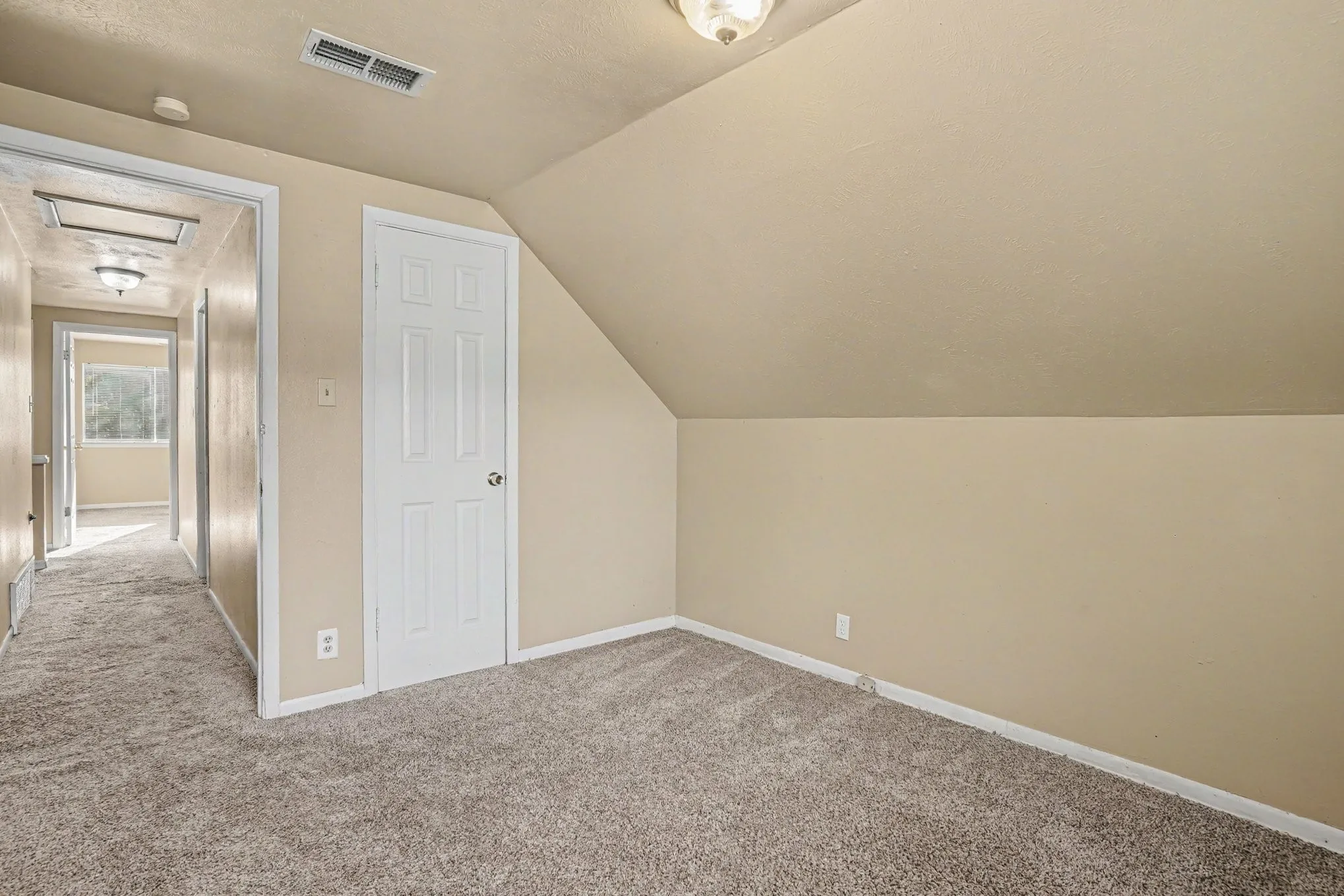 Wall-to-wall carpeting and neutral wall tones