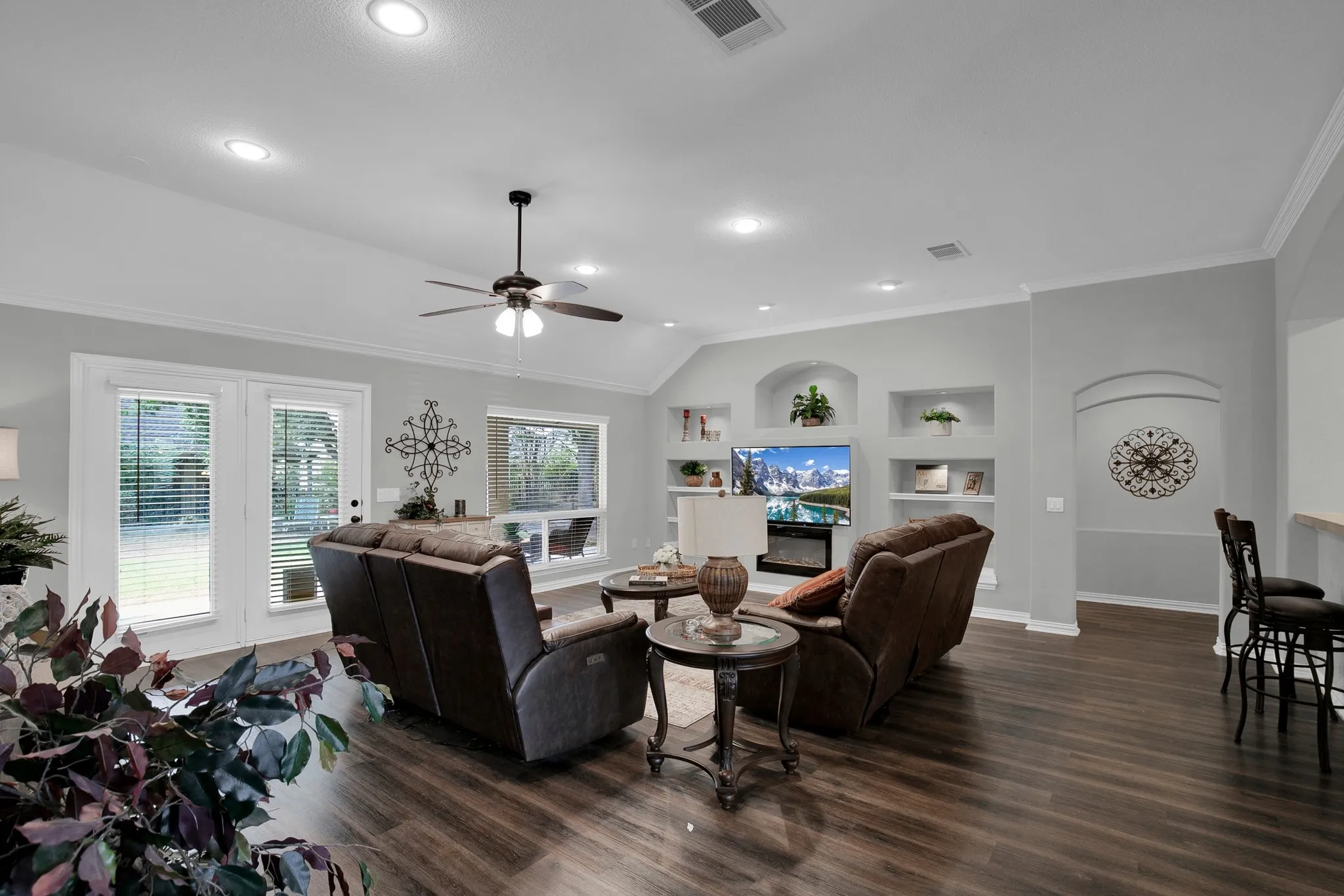 Vaulted ceiling with recessed lighting and a ceiling fan