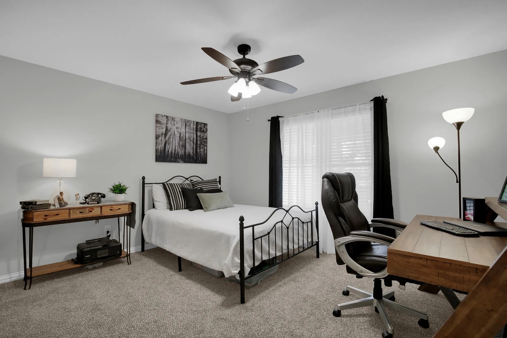 Carpeted flooring with light-toned walls, ceiling fan, and window with blinds