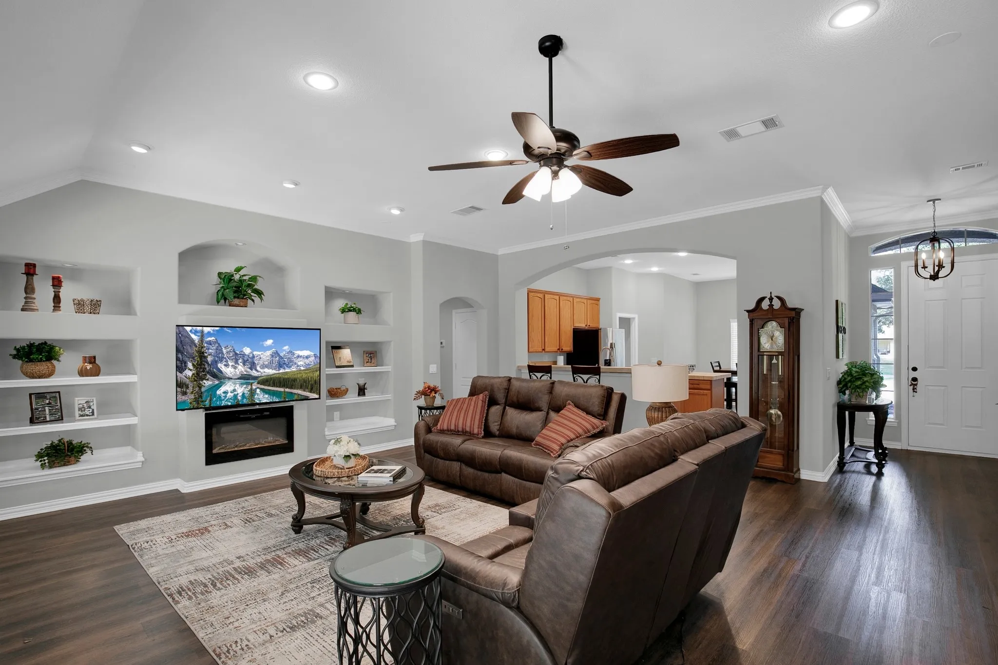 Vaulted ceiling with recessed lighting and crown molding