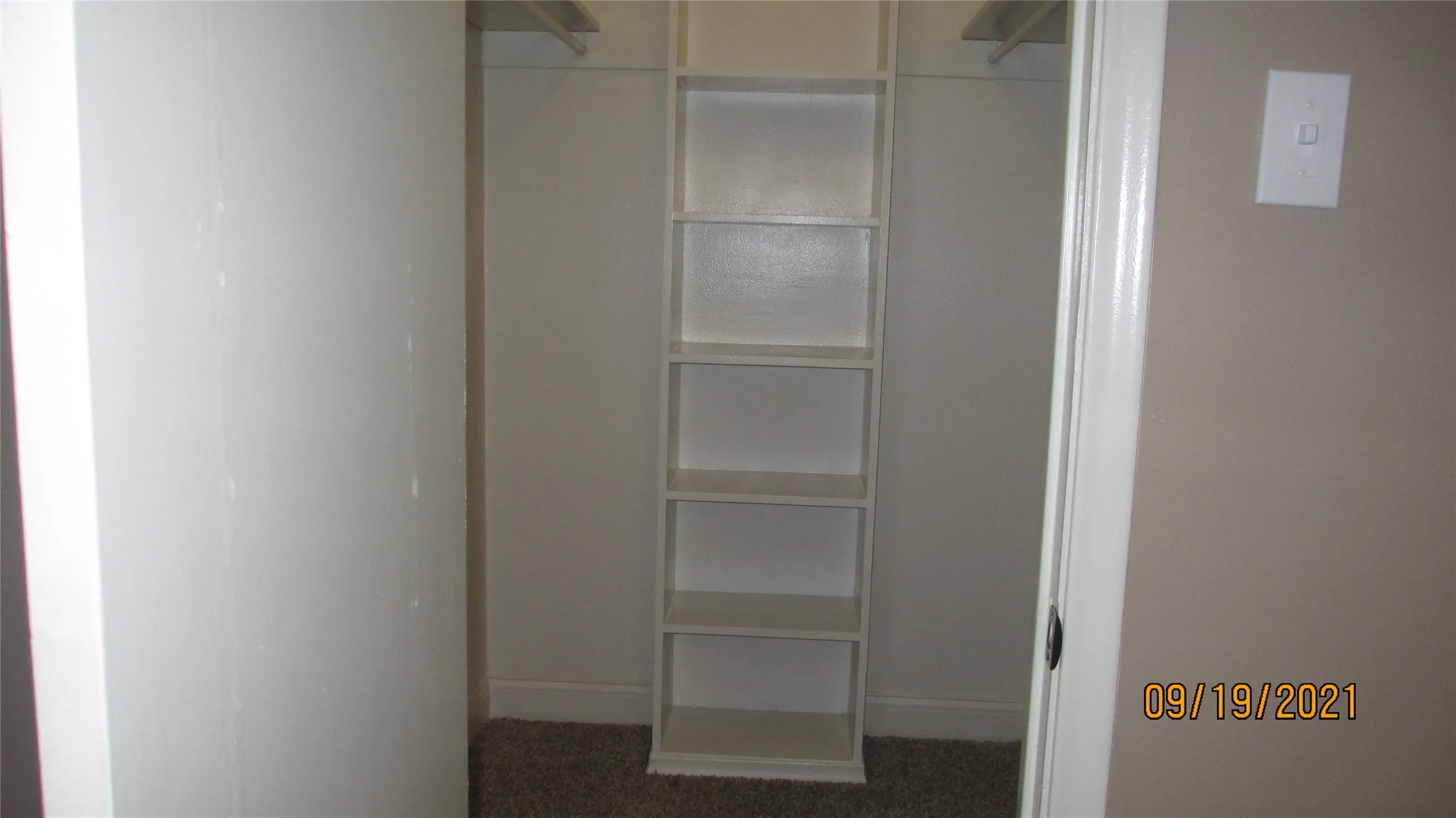 Walk in closet has shelves
