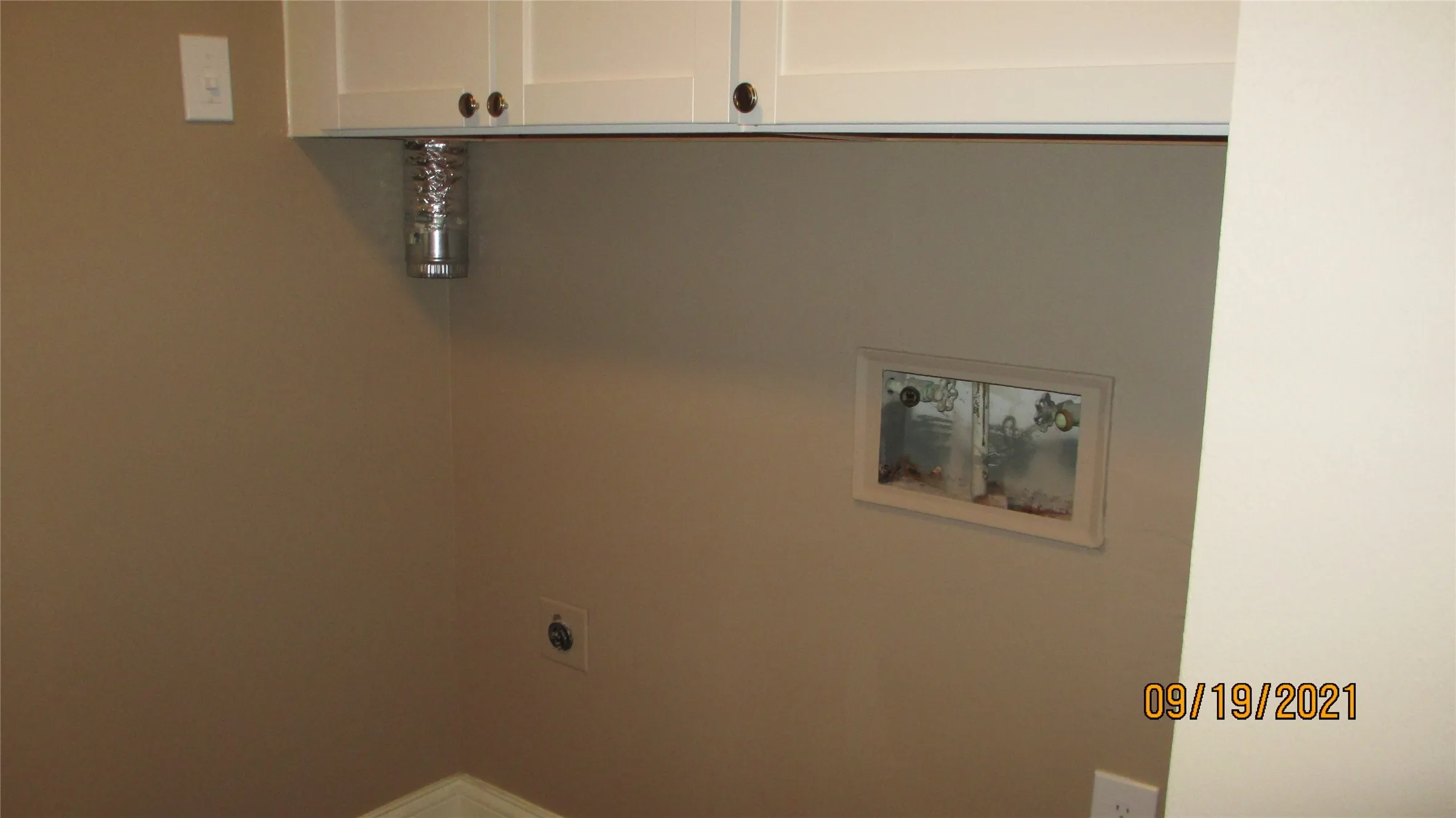 Washer and dryer area with built in cabinets