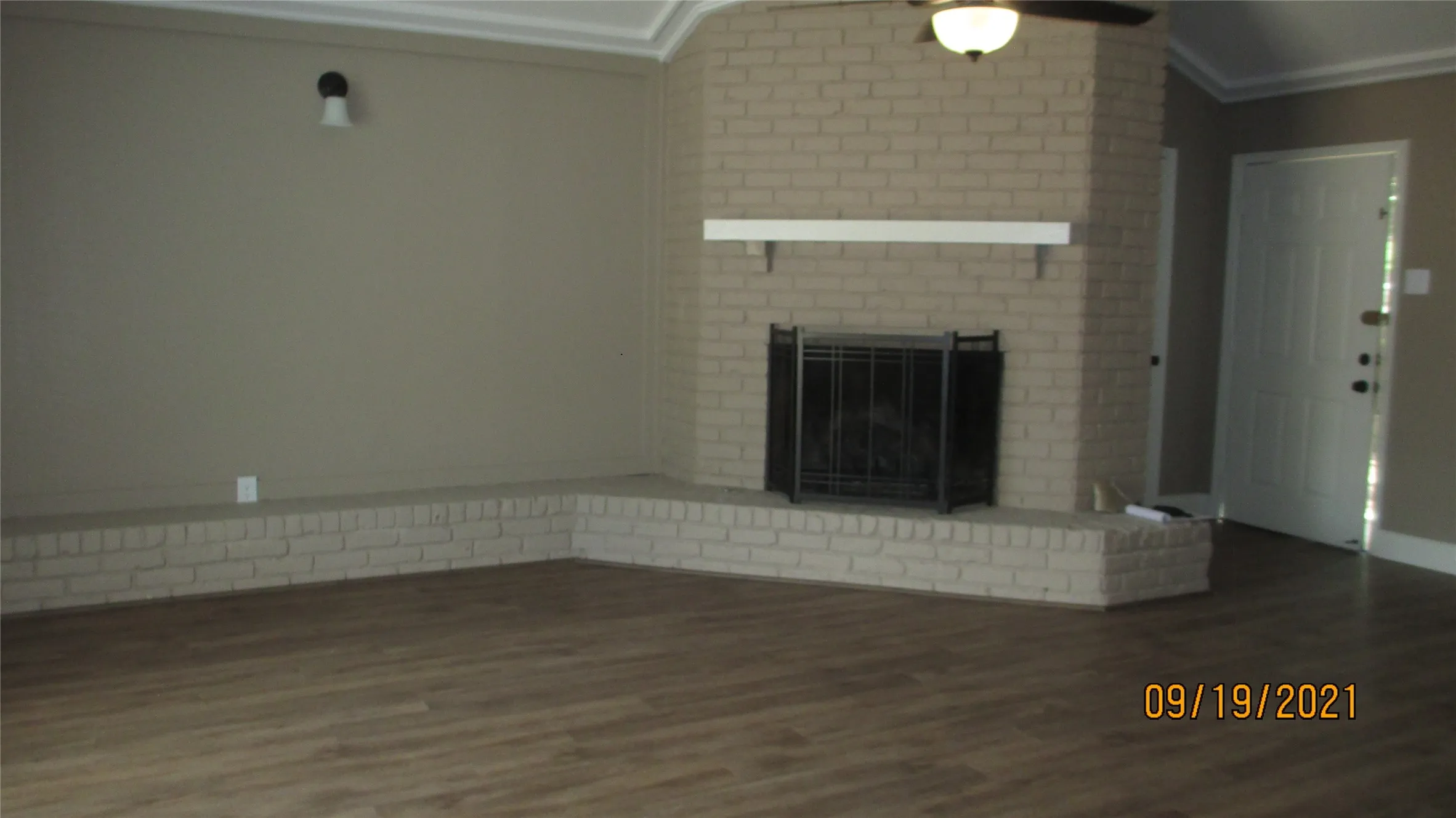 Great fireplace with gas logs, designer paint and wood floors