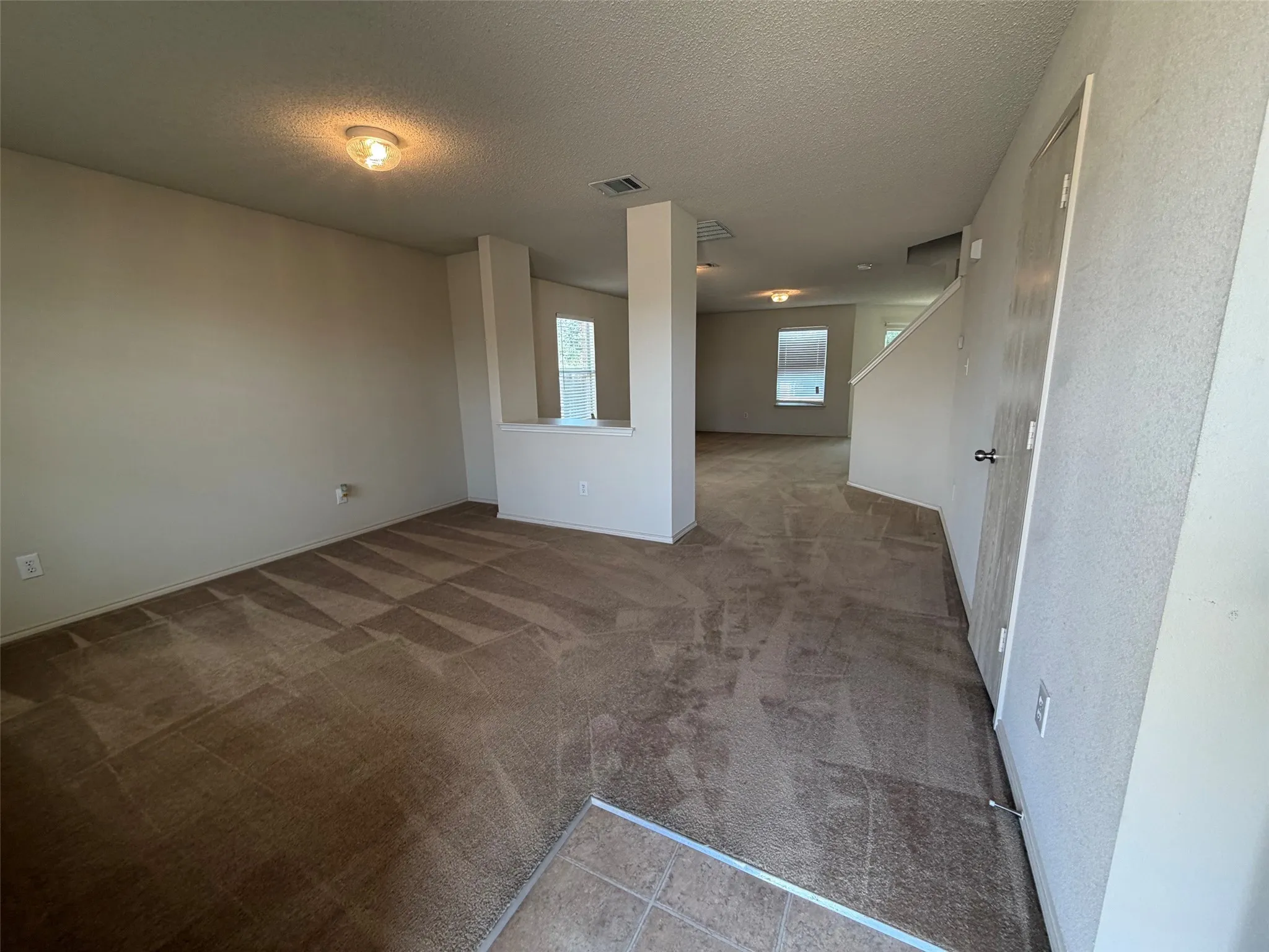 Living room from entry flowing into formal dining room.