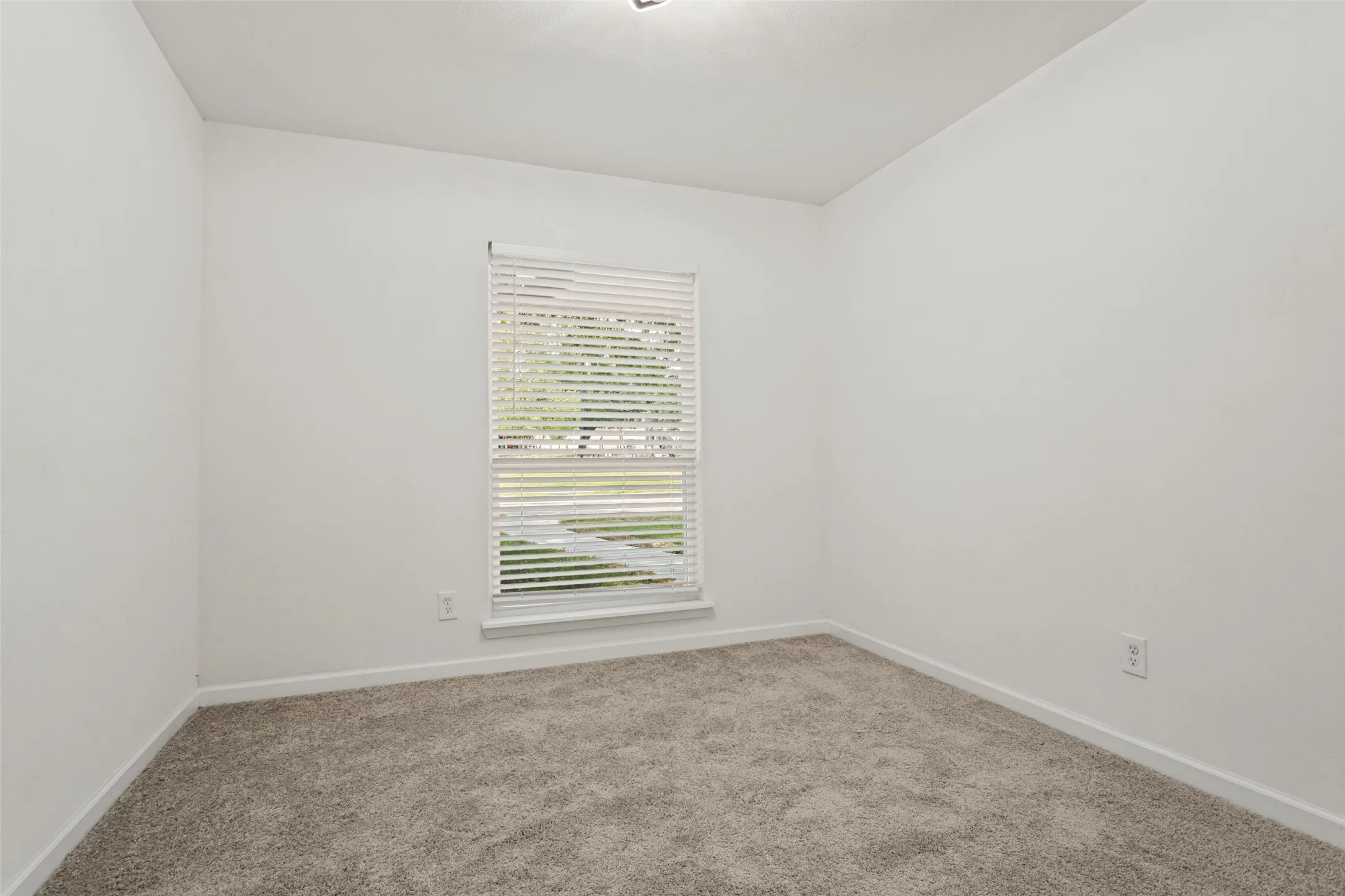 Carpeted flooring, white walls, window with blinds, and recessed ceiling light