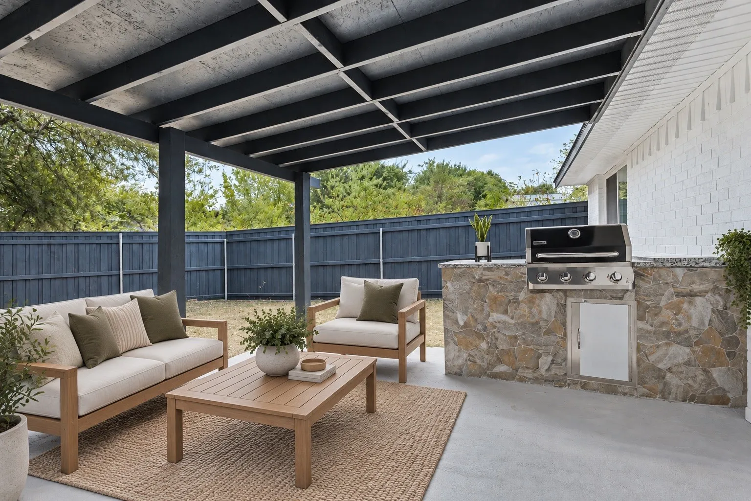 Expansive covered patio featuring a built-in outdoor kitchen with stone veneer and granite countertop