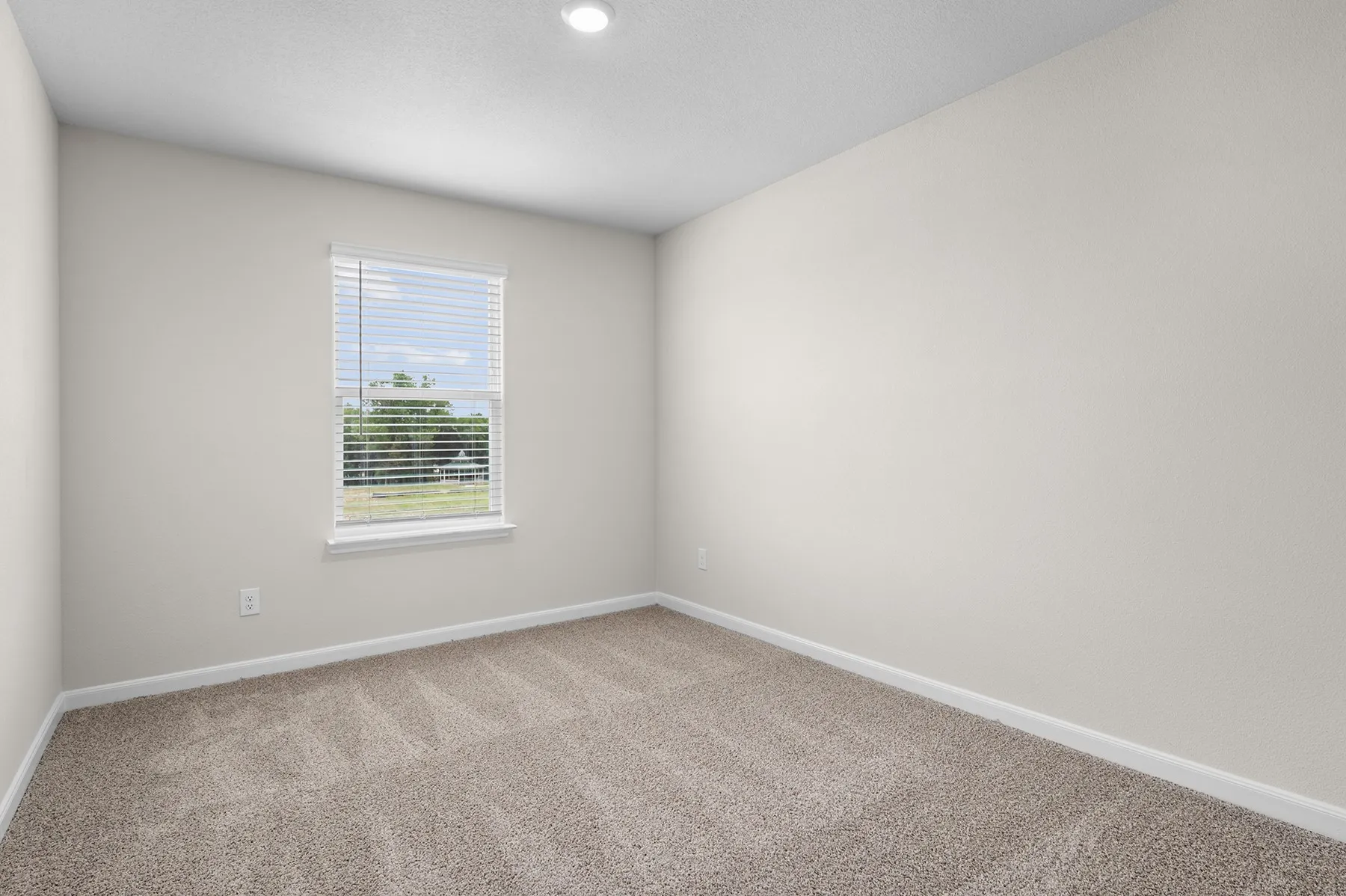 Empty room featuring baseboards and carpet floors