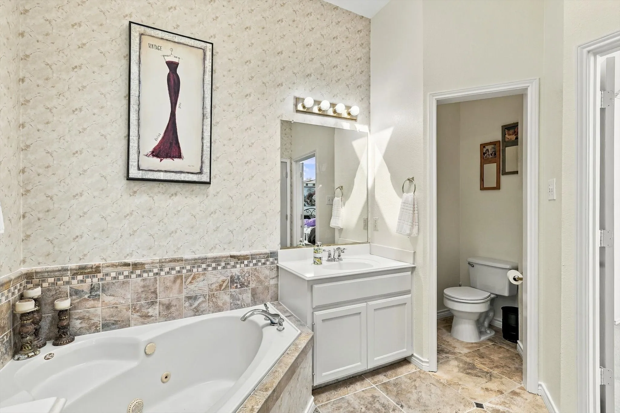 Built-in jetted tub with tiled surround and decorative accent border
