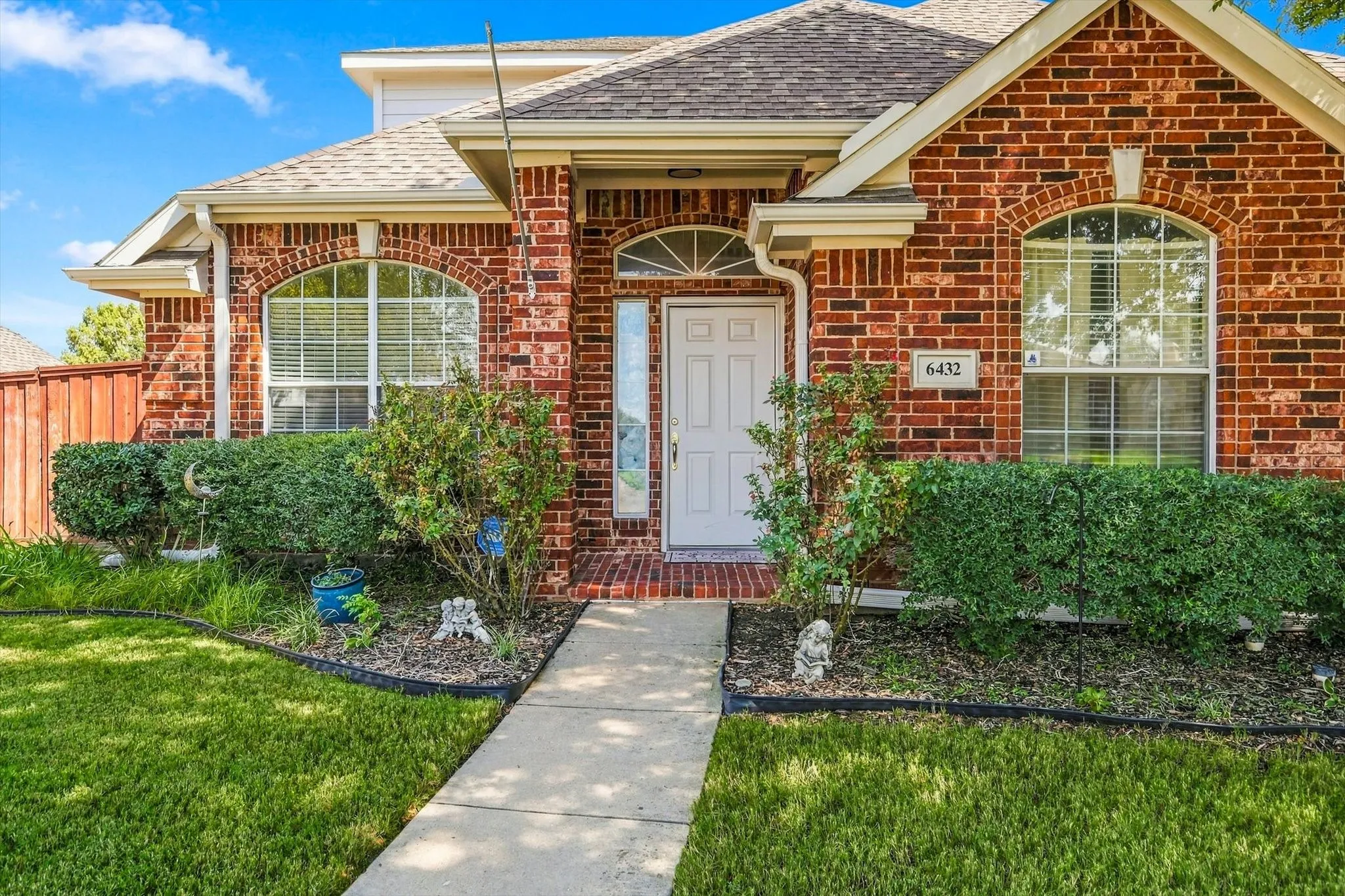 Brick exterior with an arched window and white trim