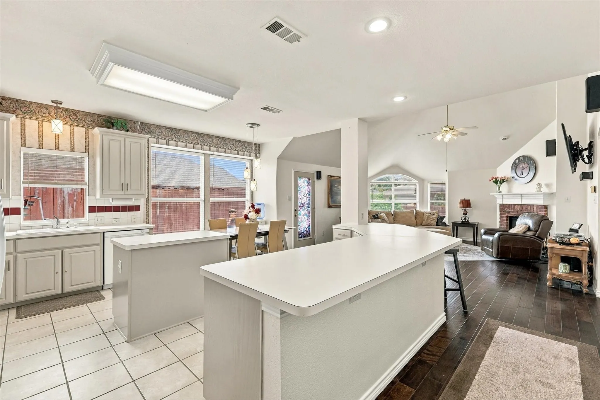 Kitchen with white cabinetry, tile flooring, and a breakfast bar