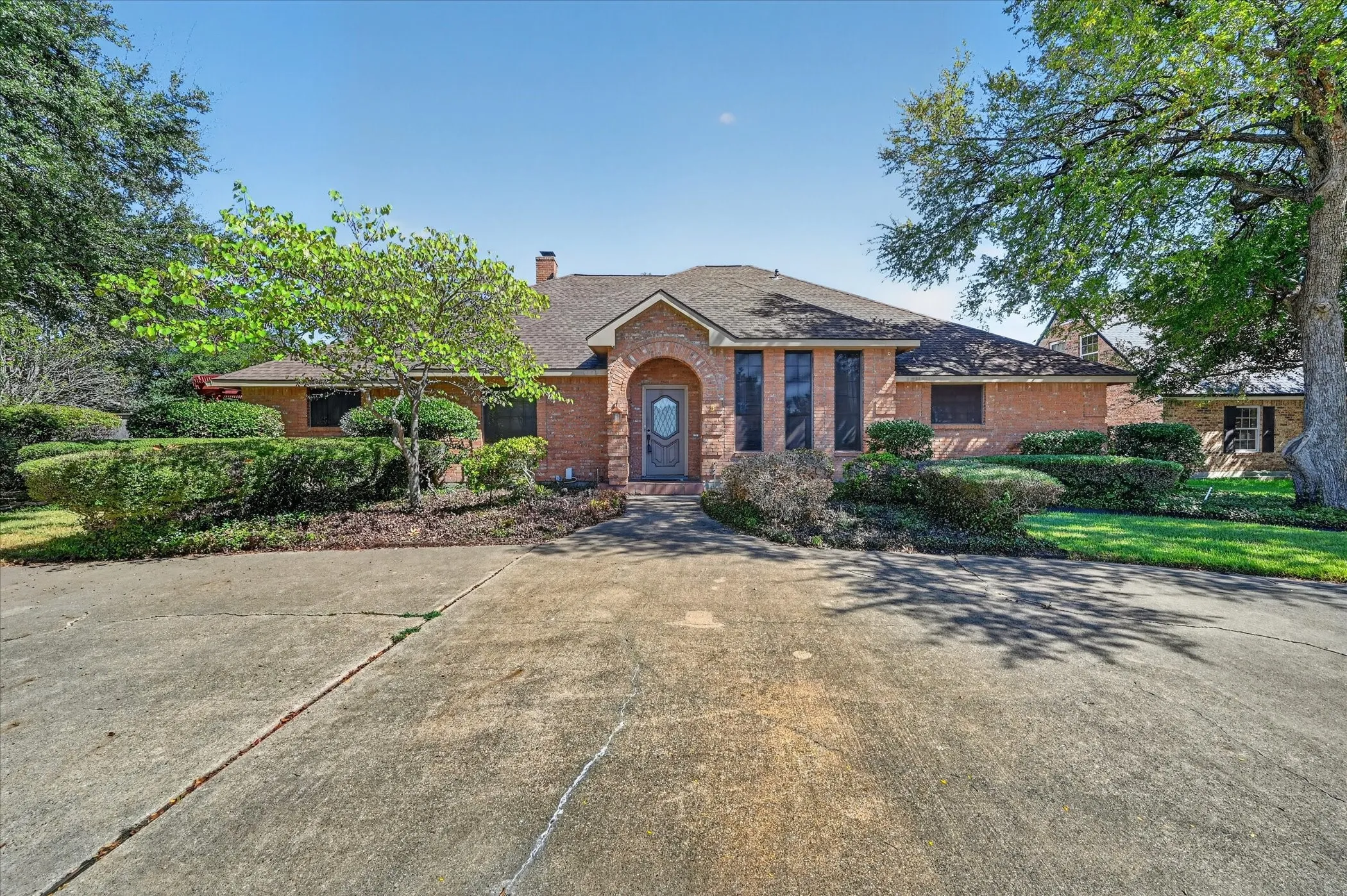 Brick exterior with a gabled roof and arched entryway