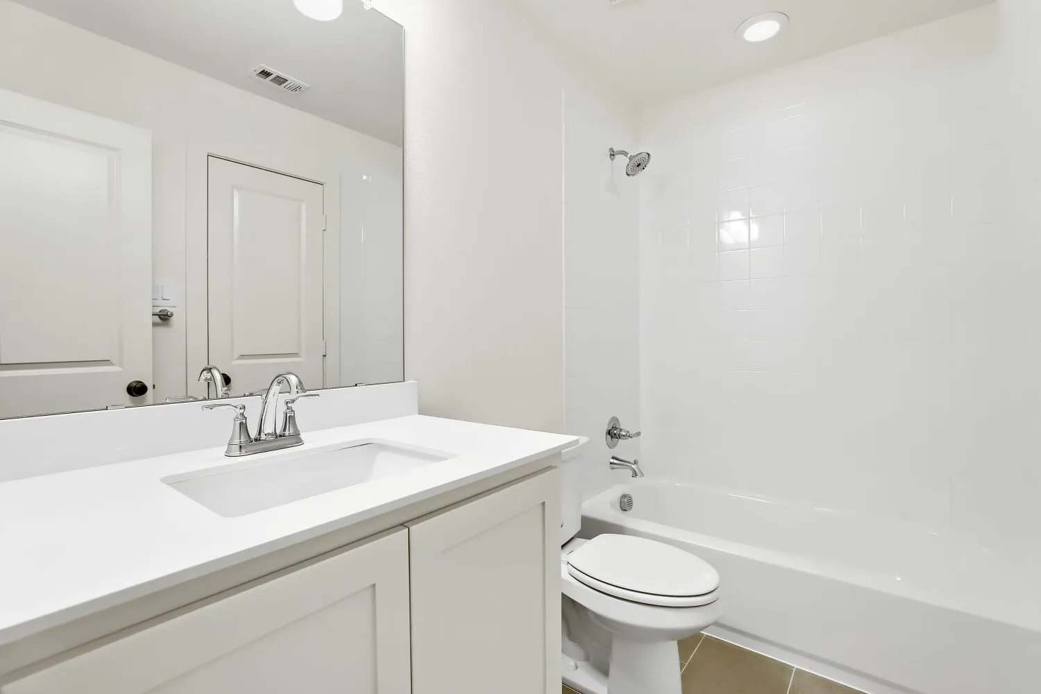 White vanity with integrated rectangular sink and chrome faucet