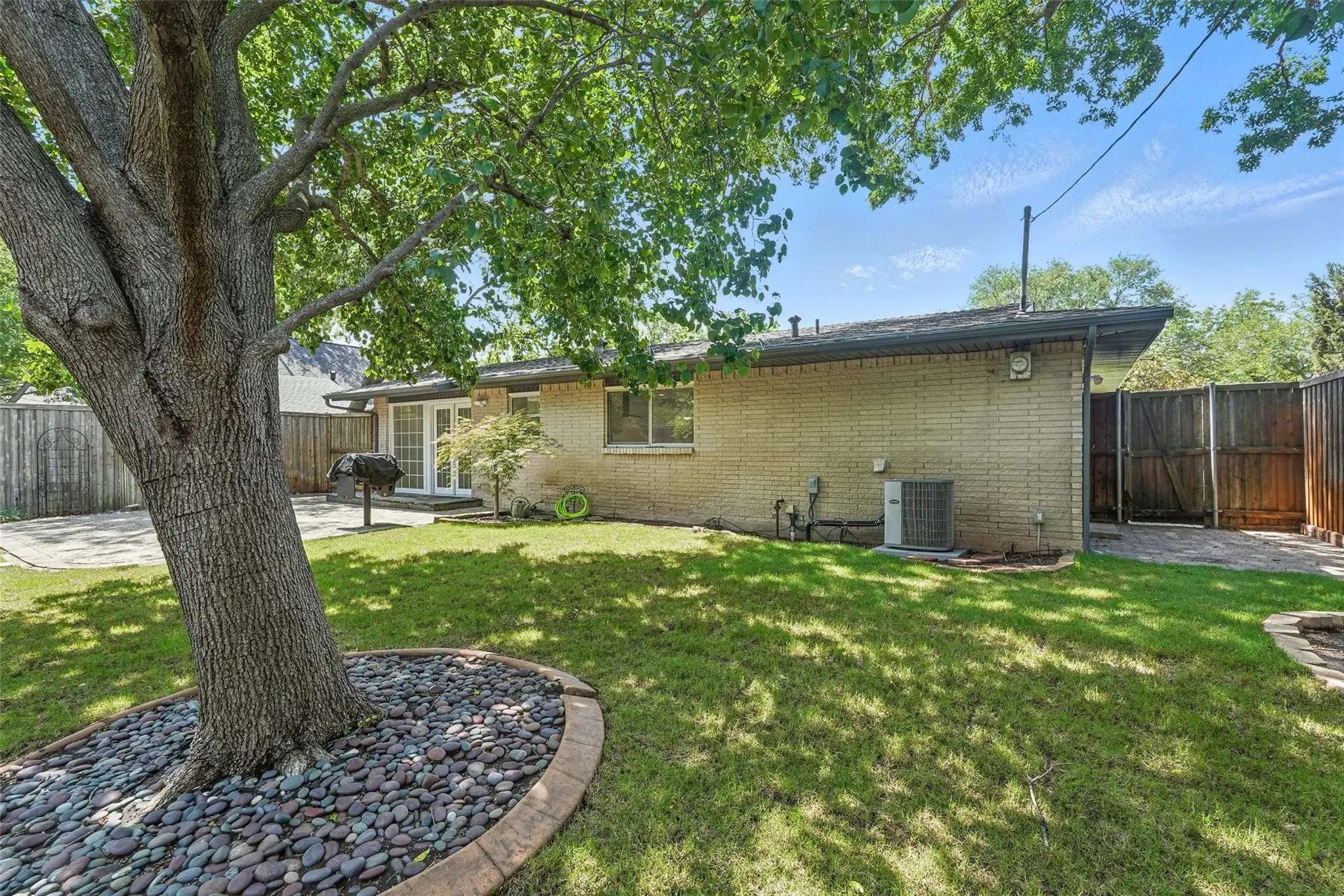 Large fenced yard with sprinkler system