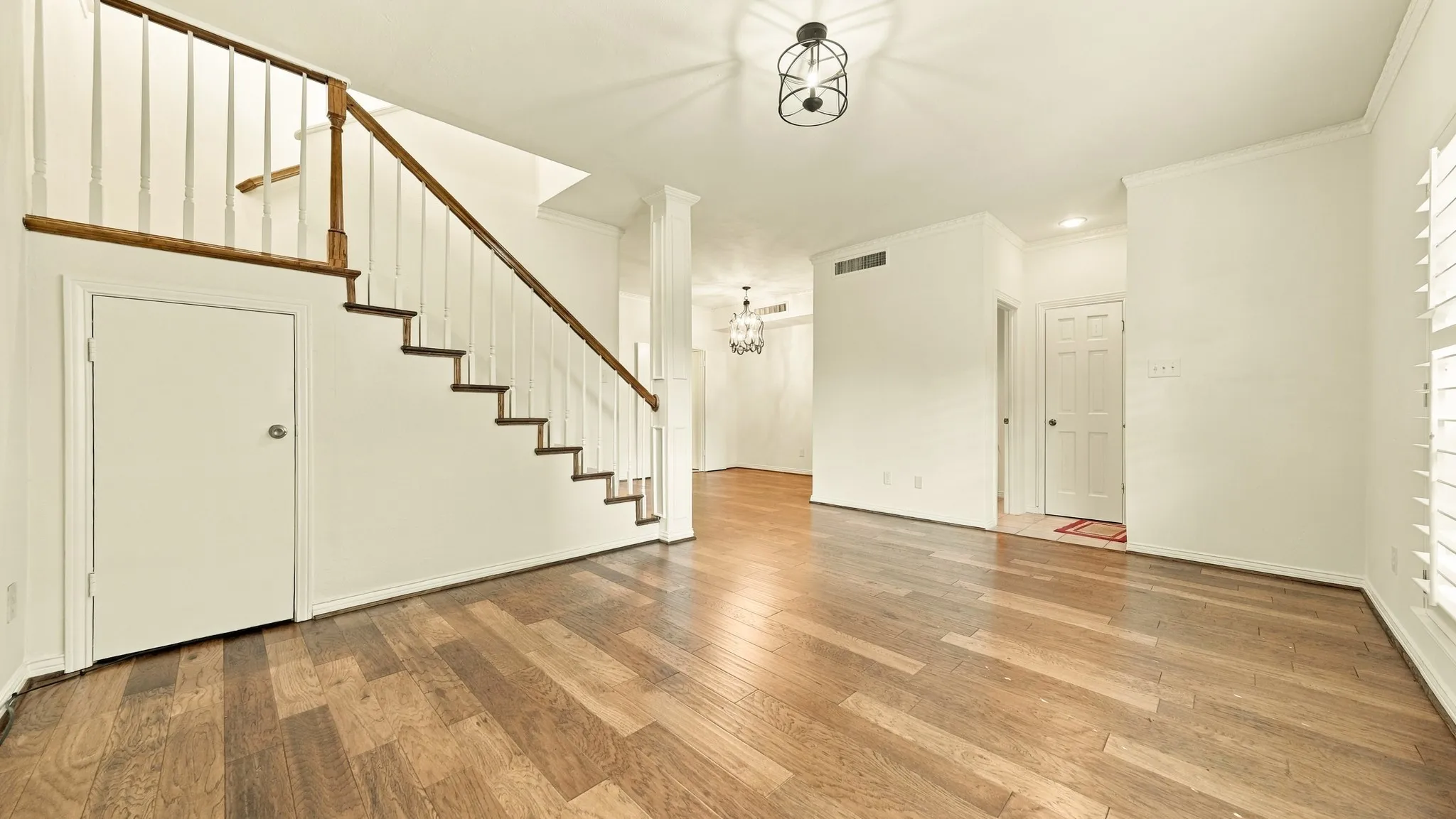 living room & dining, newer wood stairs, storage under stairs