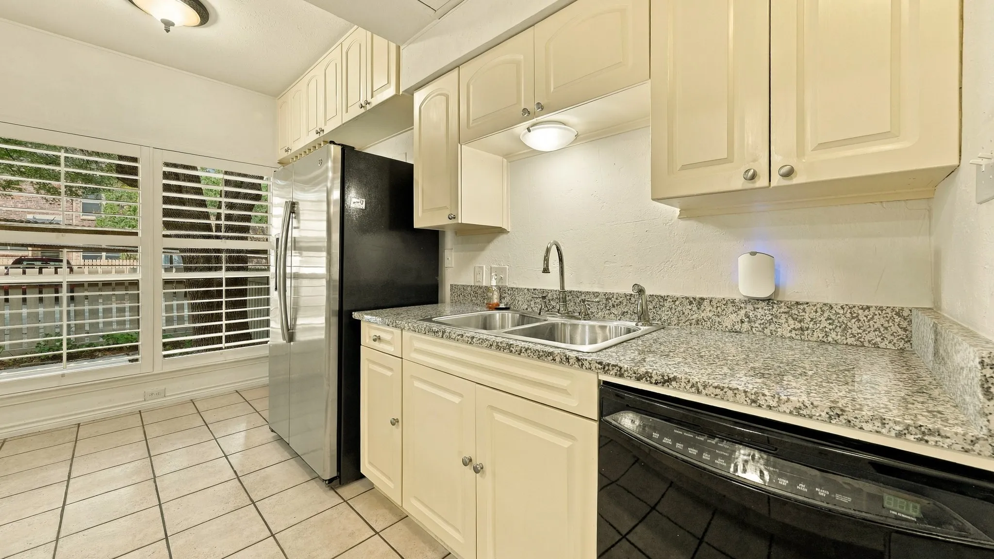 granite, newer cabinetry above frig, newer windows and shutters