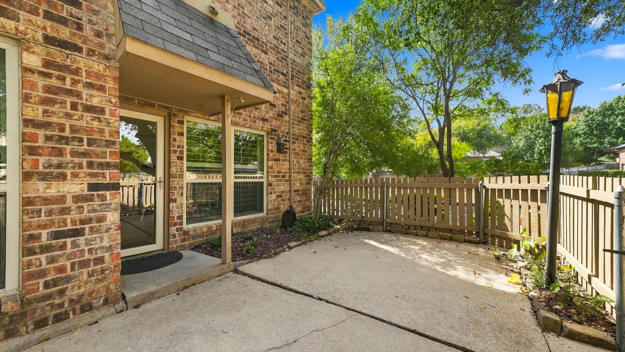 back patio facing greenbelt,Trails & creek with stately trees, den windows, screened door like a window