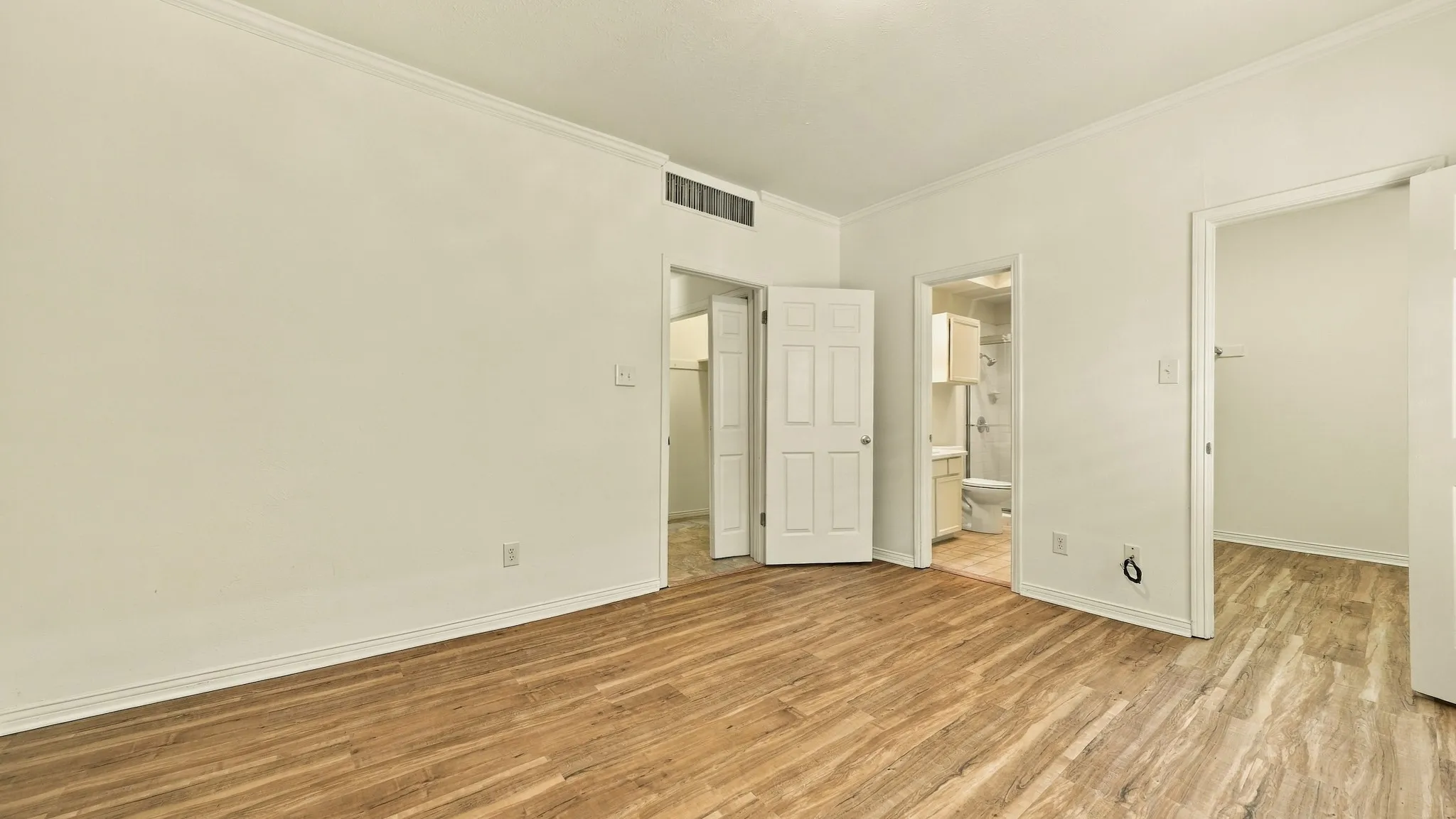 crown molding, newer luxury vinyl floors, large closet, full bath lots of cabinets, large mirror