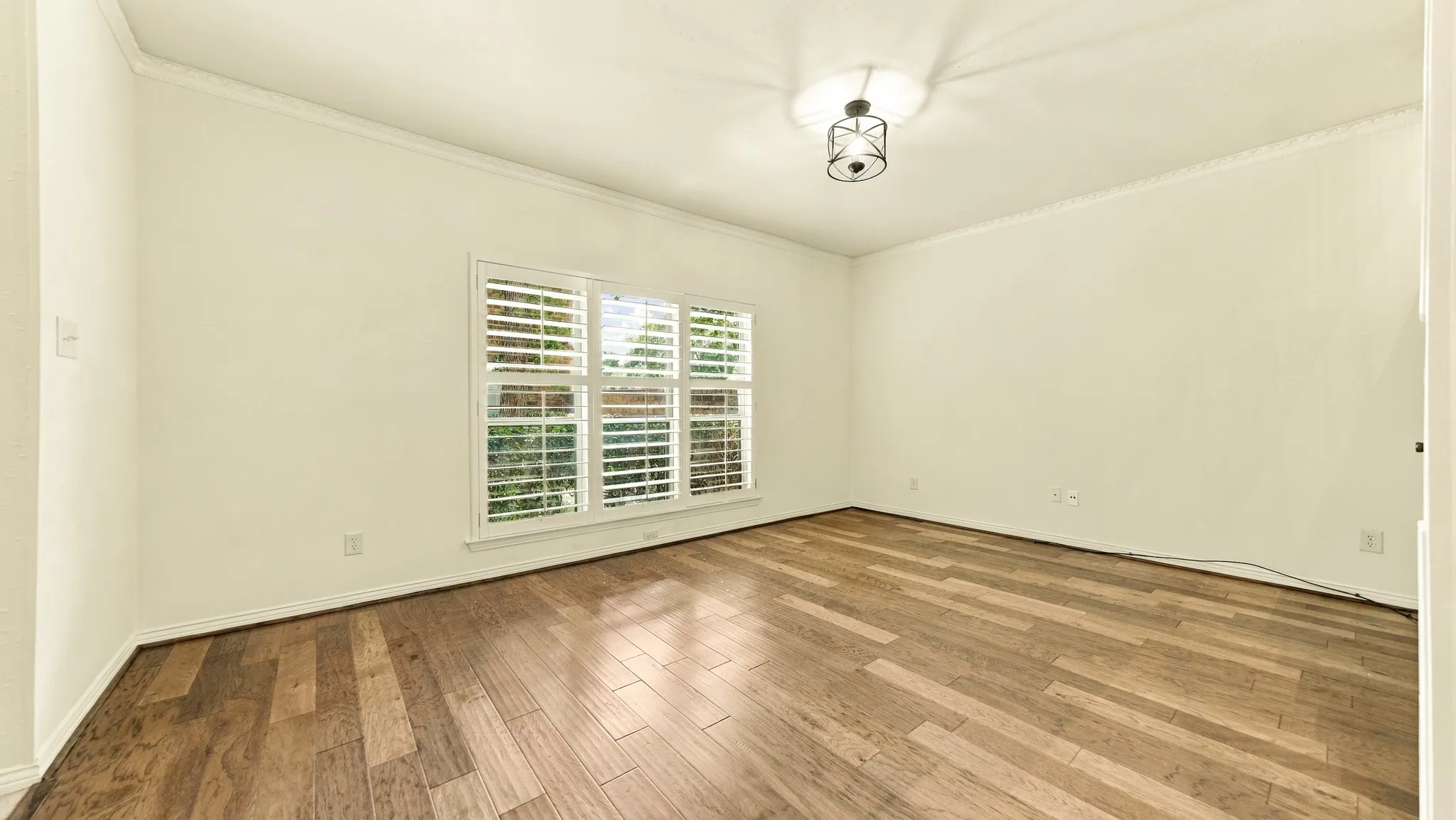 high ceilings, crown molding, wood plank flooring, newer windows, plantation shutters
