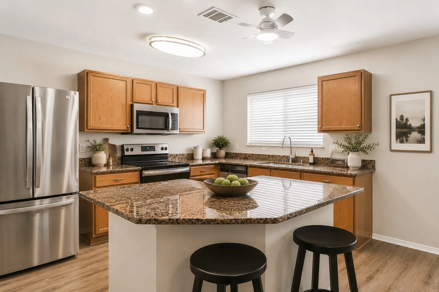 Kitchen featuring stainless steel appliances, wood-finish cabinetry, granite countertops, an island with seating, and wood-finish flooring